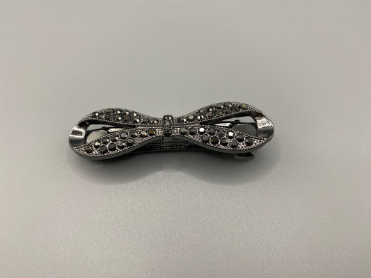 Jasmine Dazzling Hair Clip in Black with a rhinestone bow design featuring sparkling black zirconia inset stones. Measures 6cm, crafted from high-quality metal for durability. Elegant and versatile, perfect for both special occasions and everyday wear.”