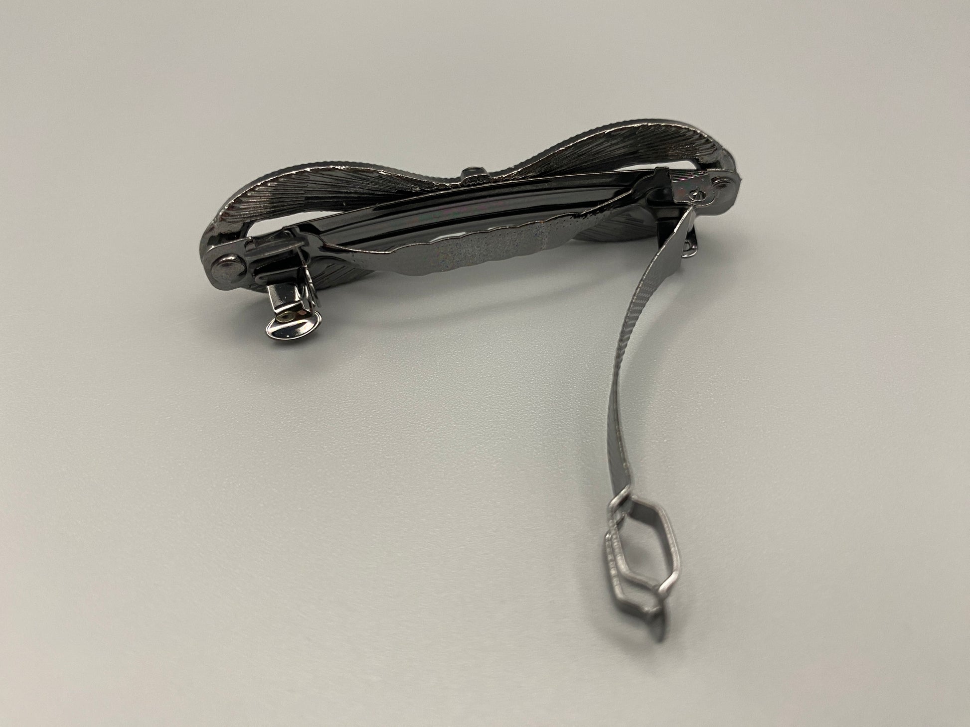 Jasmine Dazzling Hair Clip in Black with a rhinestone bow design featuring sparkling black zirconia inset stones. Measures 6cm, crafted from high-quality metal for durability. Elegant and versatile, perfect for both special occasions and everyday wear.”