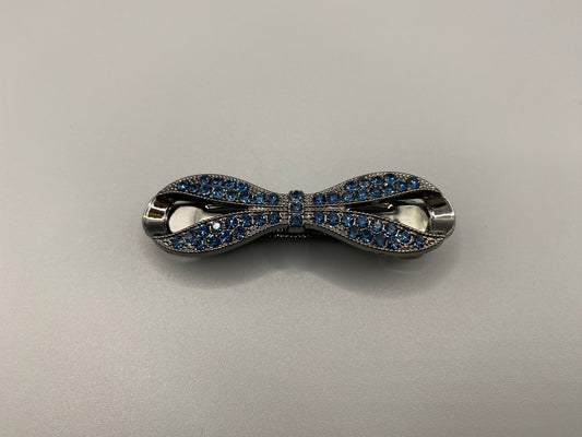 “Jasmine Dazzling Hair Clip in Blue with a rhinestone bow design featuring sparkling blue zirconia inset stones. Measures 6cm, crafted from high-quality metal for durability. Elegant and versatile, perfect for both special occasions and everyday wear.”