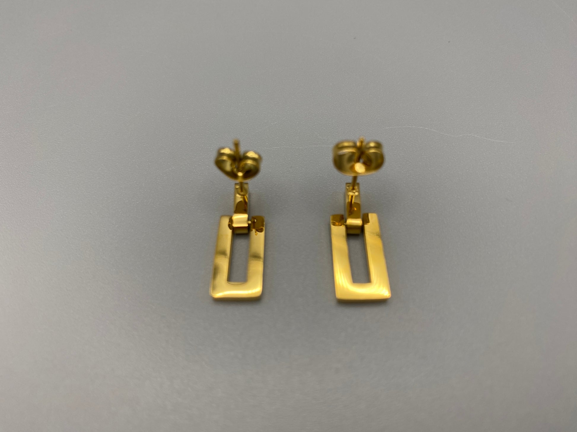 “Josephine Earrings Gold: Vintage-inspired charm earrings crafted from high-quality stainless steel and plated with 18K gold, featuring a sleek rectangular shape. Perfect for various occasions.”