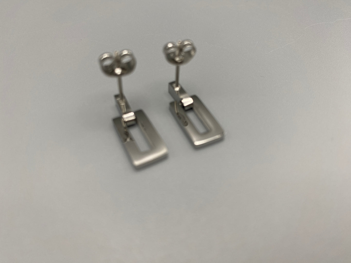 “Josephine Earrings Silver: Vintage-inspired charm earrings crafted from high-quality stainless steel and plated in silver, featuring a sleek rectangular shape. Perfect for various occasions.”