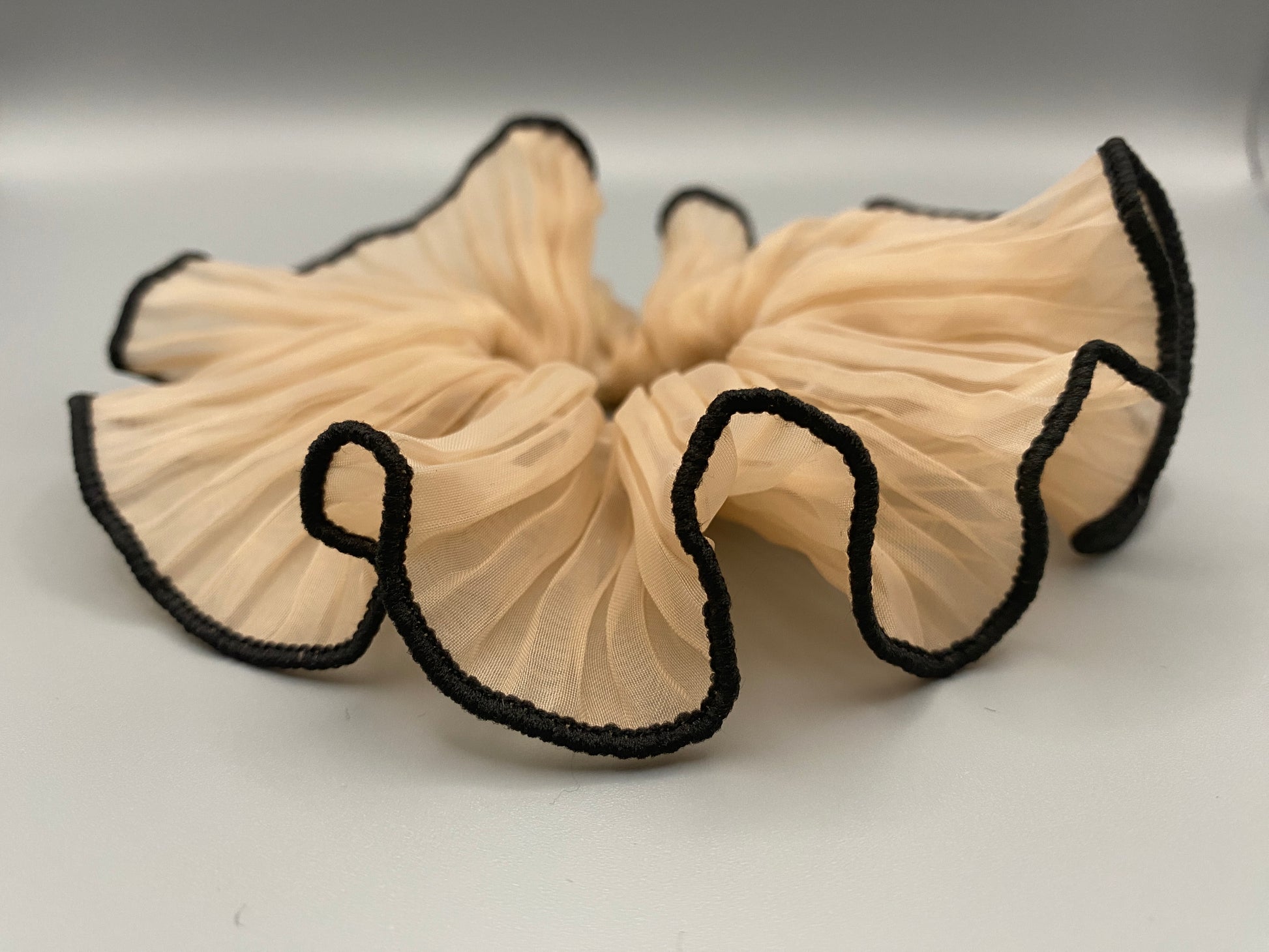 “Juliette Nude Colour French Style Scrunchie, a chic and elegant hair accessory perfect for various hairstyles. Made from high-quality material for durability and style.”
