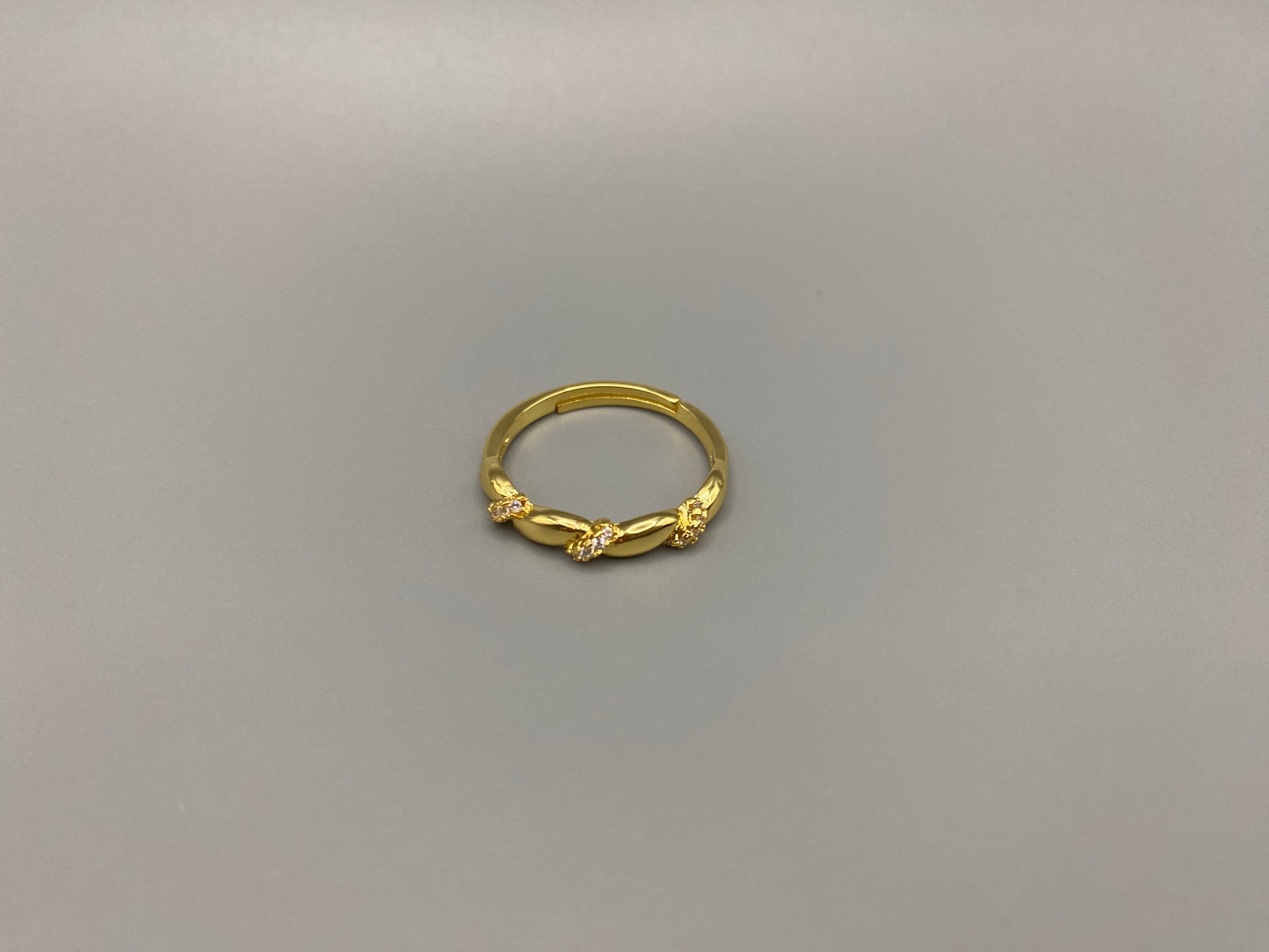 Olivia Adjustable Ring Gold: This exquisite piece is 18k gold plated, offering a luxurious shine and timeless appeal. The ring is waterproof and non-tarnish, ensuring it maintains its beauty over time. Cubic zirconia accents add sparkle and elegance, while the adjustable design ensures a perfect fit for any finger size. Make a statement with this stunning piece that complements any look.