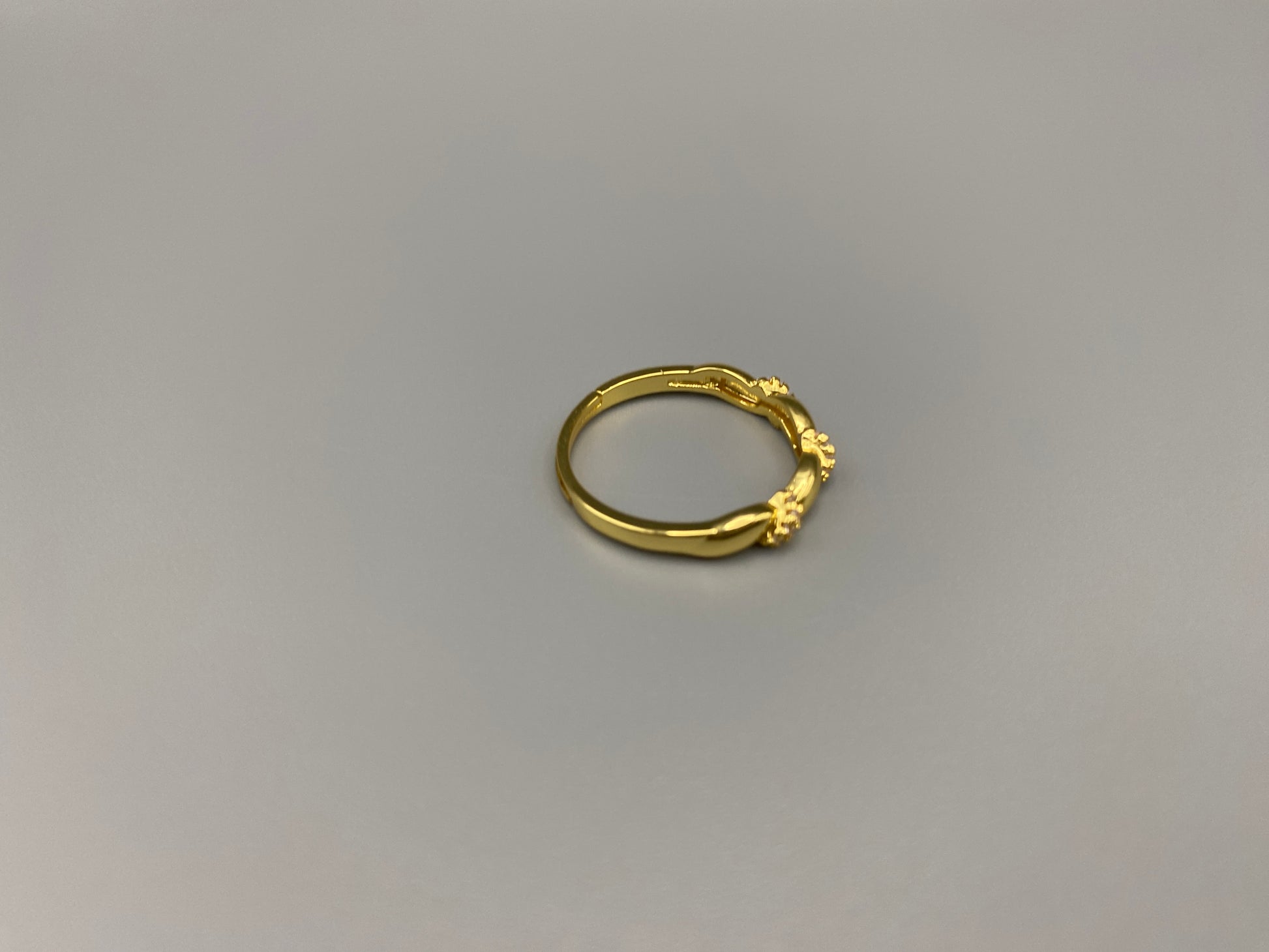 Olivia Adjustable Ring Gold: This exquisite piece is 18k gold plated, offering a luxurious shine and timeless appeal. The ring is waterproof and non-tarnish, ensuring it maintains its beauty over time. Cubic zirconia accents add sparkle and elegance, while the adjustable design ensures a perfect fit for any finger size. Make a statement with this stunning piece that complements any look.