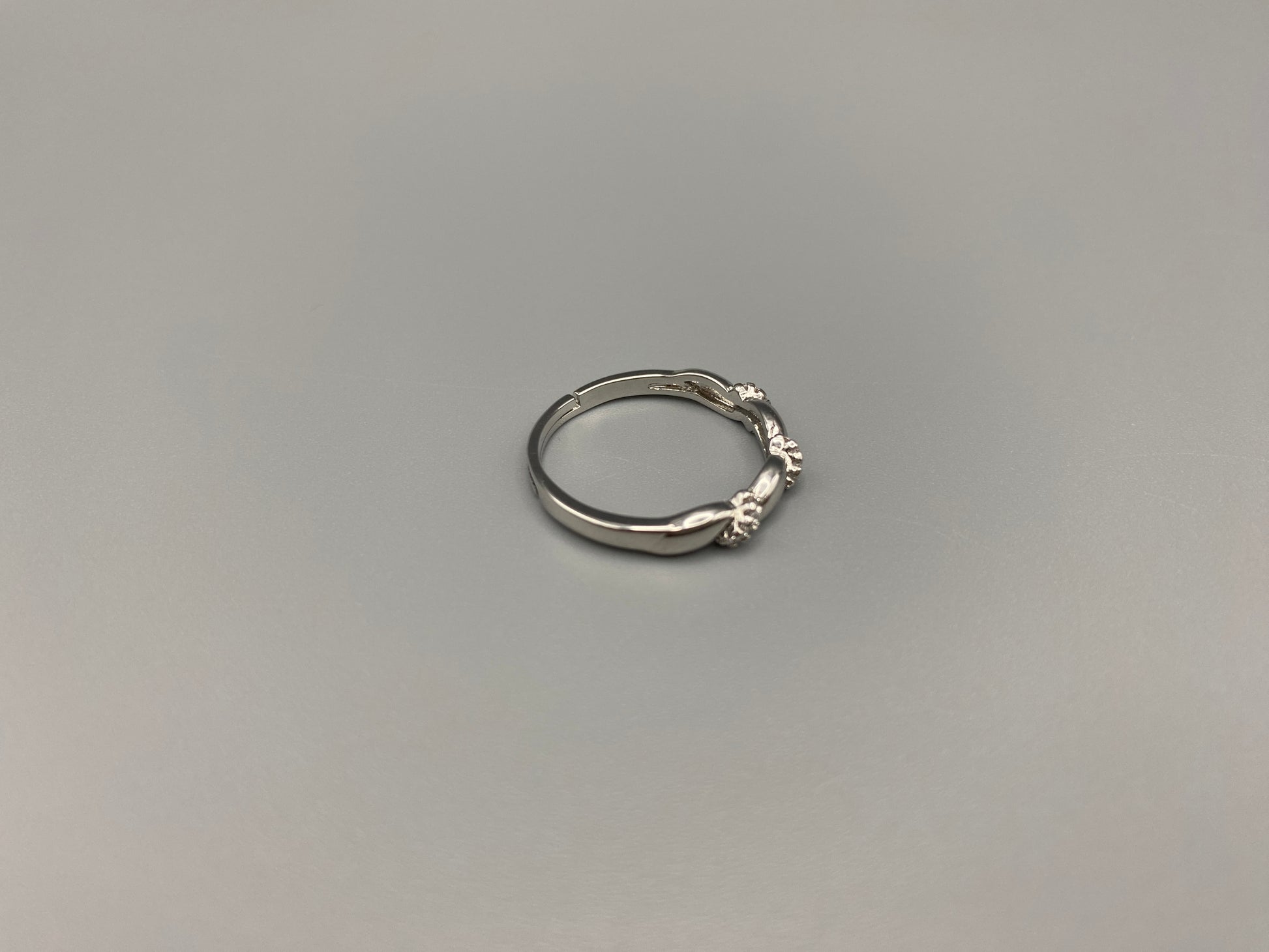 Olivia Adjustable Ring Silver: This exquisite piece plated, offering a luxurious shine and timeless appeal. The ring is waterproof and non-tarnish, ensuring it maintains its beauty over time. Cubic zirconia accents add sparkle and elegance, while the adjustable design ensures a perfect fit for any finger size. Make a statement with this stunning piece that complements any look.