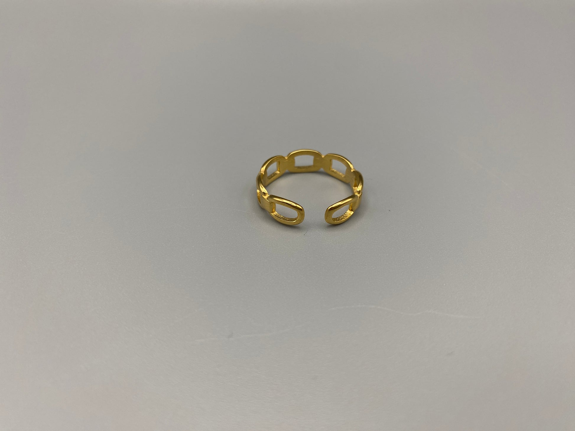 Phoebe Gold Ring: Discover the Phoebe Gold Ring, a fashionable and versatile piece perfect for any occasion. This 18K gold-plated stainless steel ring features a hollow geometric link chain design. It is resizable to size 6, making it a trendy and adaptable accessory. Ideal for daily wear or special events like anniversaries and parties, this ring is both nickel-free and lead-free, ensuring it is safe for all skin types.