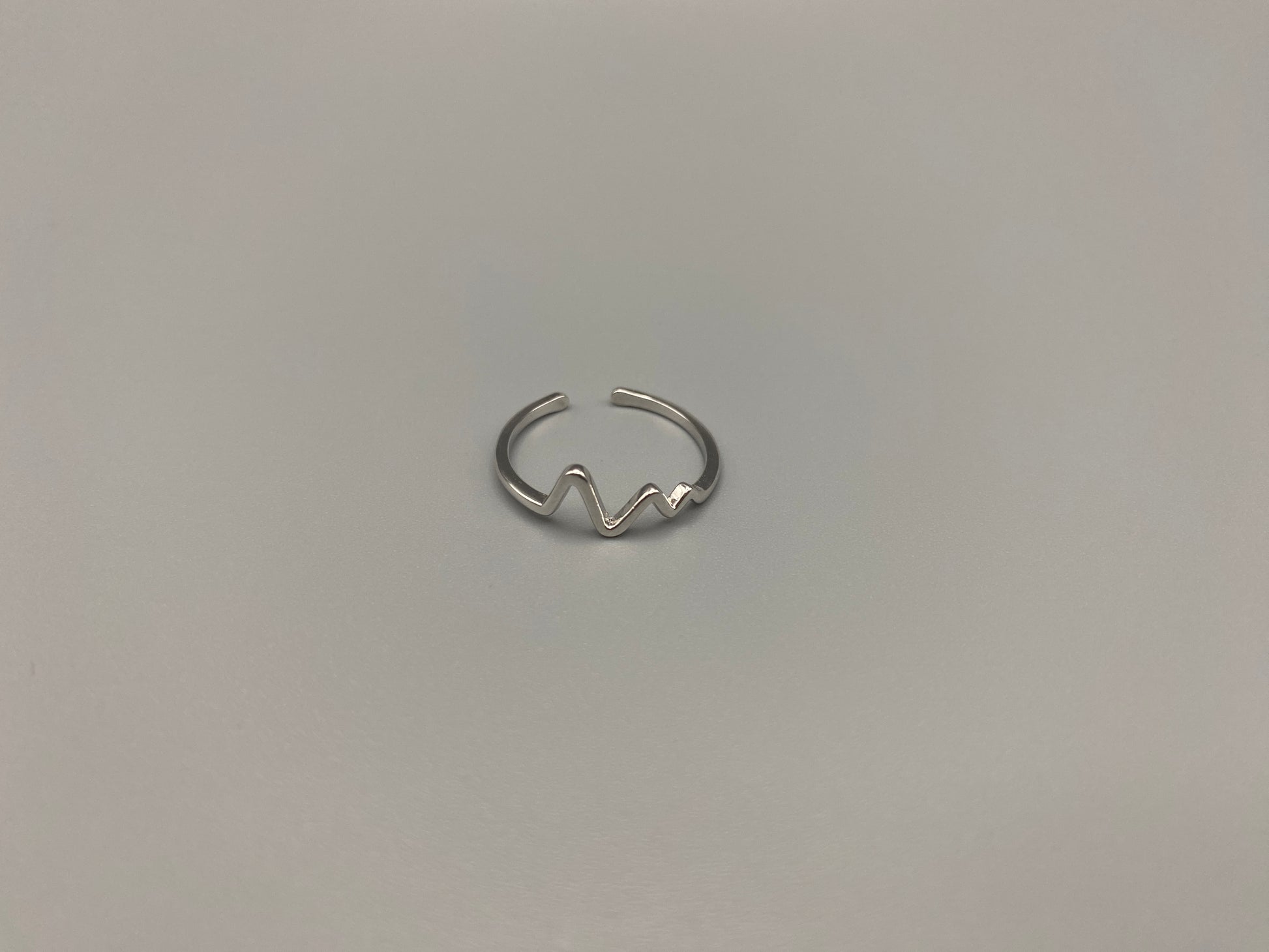 Pulse Ring Silver: This adjustable ring features a heartbeat pattern, crafted from high-quality 925 sterling silver and plated with a non-tarnish, waterproof finish. It is designed to be anti-allergy, making it perfect for any occasion, whether it’s an anniversary, engagement, wedding, or party.
