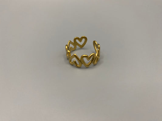 Ring Of Hearts Gold: Embrace elegance and modernity with our Ring of Hearts. Crafted from high-quality stainless steel and plated with 18K gold, this trendy geometric ring features interconnected hearts. Symbolizing unity and love, this adjustable ring is a versatile accessory for any occasion.