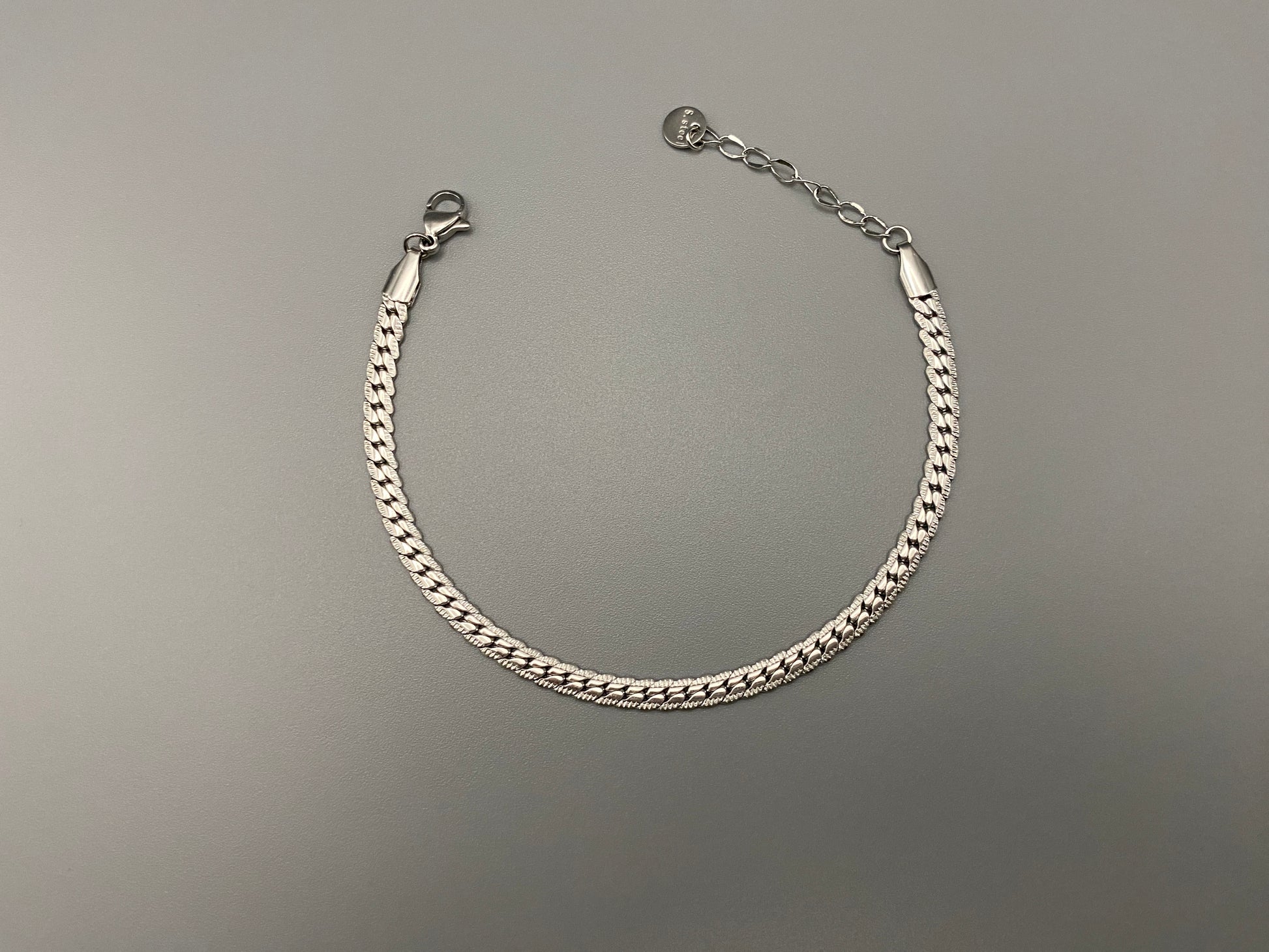 “Seraphina Bracelet in Silver with a unique snake-linked design, featuring luxurious Silver plating. Adjustable length of 17 cm with a 3 cm extension. Durable construction ensures long-lasting wear and tarnish resistance.”