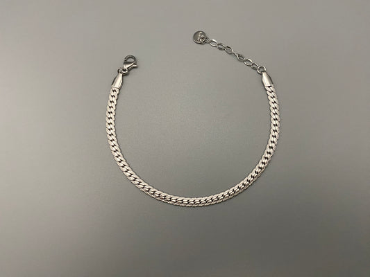 “Seraphina Bracelet in Silver with a unique snake-linked design, featuring luxurious Silver plating. Adjustable length of 17 cm with a 3 cm extension. Durable construction ensures long-lasting wear and tarnish resistance.”