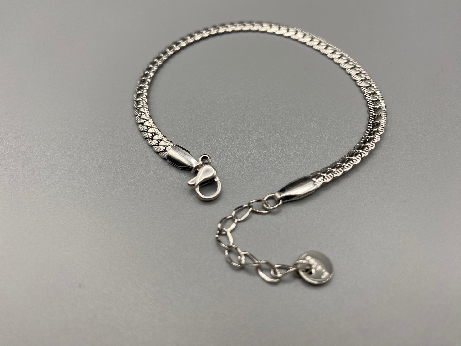 “Seraphina Bracelet in Silver with a unique snake-linked design, featuring luxurious Silver plating. Adjustable length of 17 cm with a 3 cm extension. Durable construction ensures long-lasting wear and tarnish resistance.”