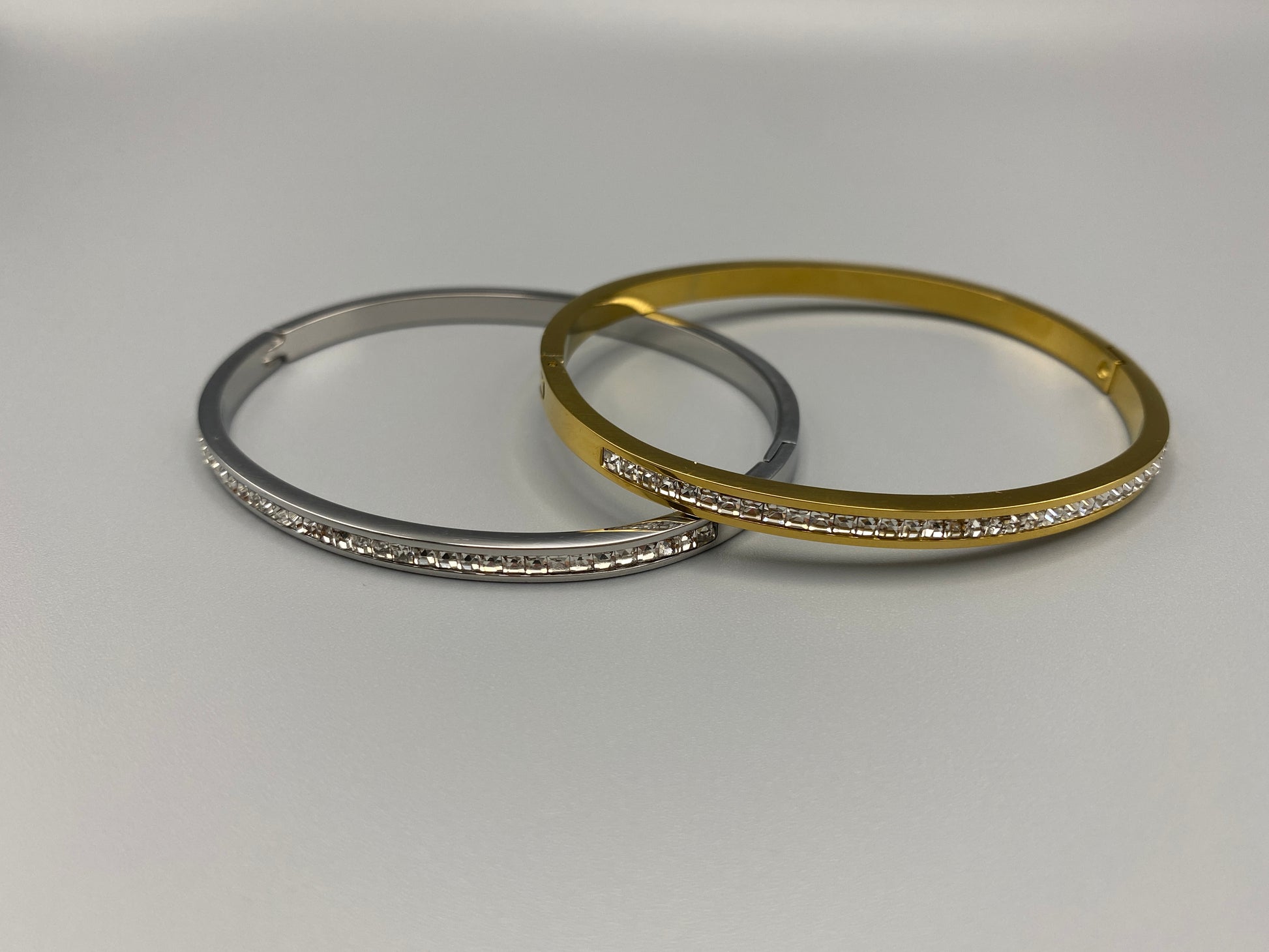 “Simone Encrusted Bangle in gold with 18K gold plating and gemstone inlay, offering a radiant and luxurious finish. Durable construction ensures long-lasting wear and tarnish resistance. Perfect for both everyday wear and special occasions.”