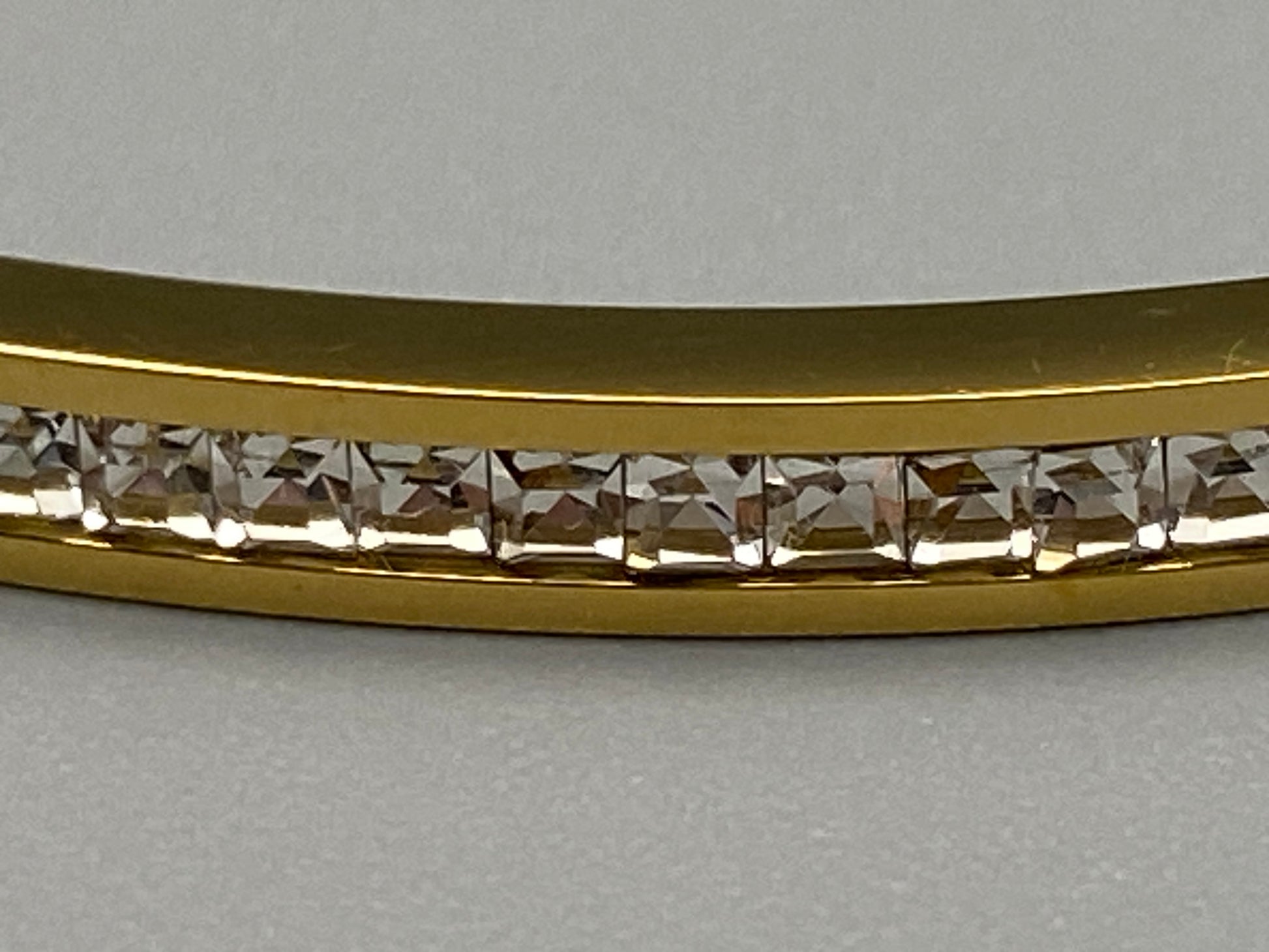“Simone Encrusted Bangle in gold with 18K gold plating and gemstone inlay, offering a radiant and luxurious finish. Durable construction ensures long-lasting wear and tarnish resistance. Perfect for both everyday wear and special occasions.”
