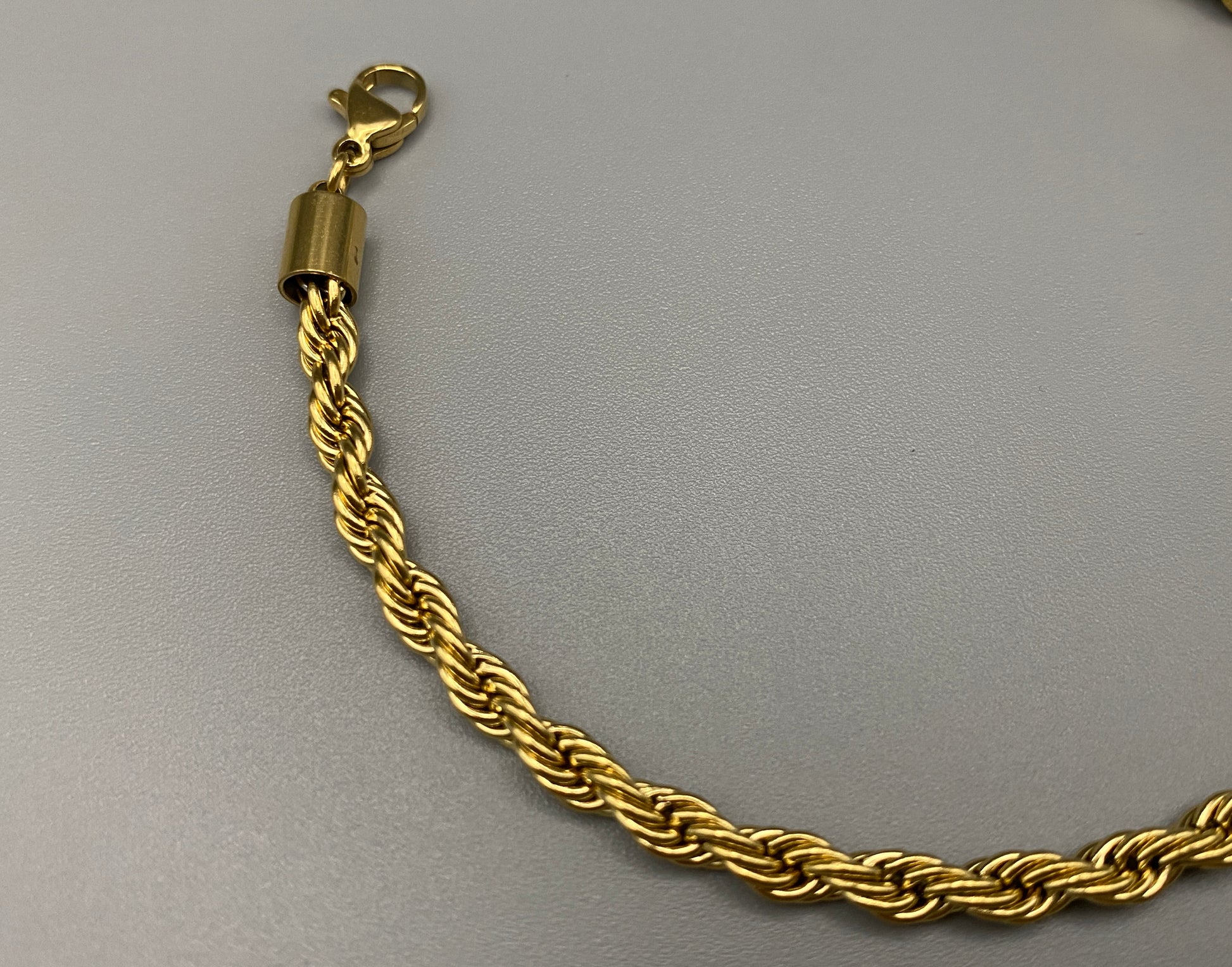 “Spiral Splendor Bracelet in gold with an intricate spiral design, featuring luxurious gold plating and PVD plating for durability. Made from stainless steel, adjustable length of 17.5 cm with a 3 cm extension.”