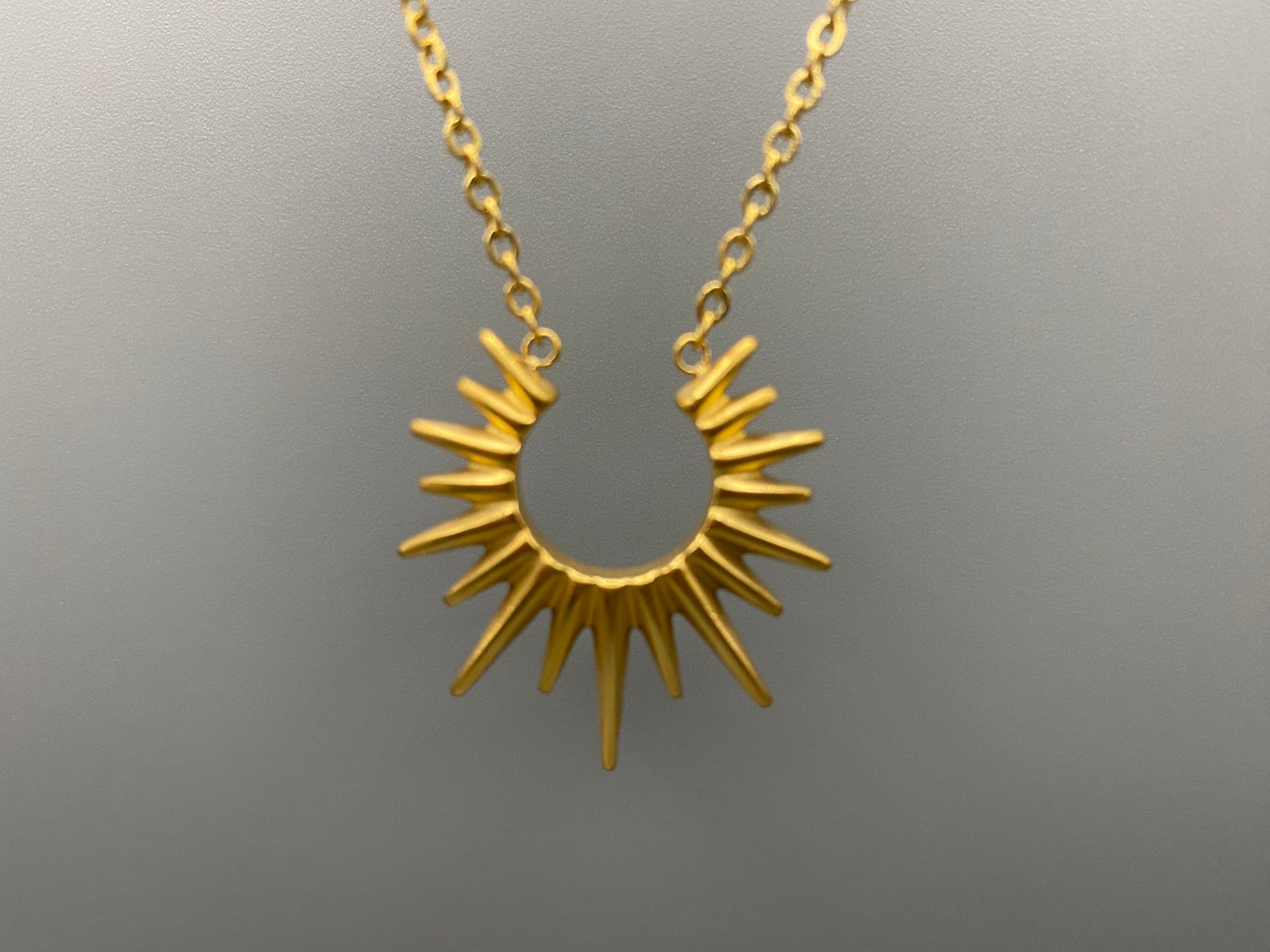 Sunburst Pendant Necklace Gold. Radiant and elegant. 18k gold plated pendant. Waterproof, non-tarnish, non-fade. Length: 45 cm + 5 cm extender. Stainless steel construction. Unique sunburst design.