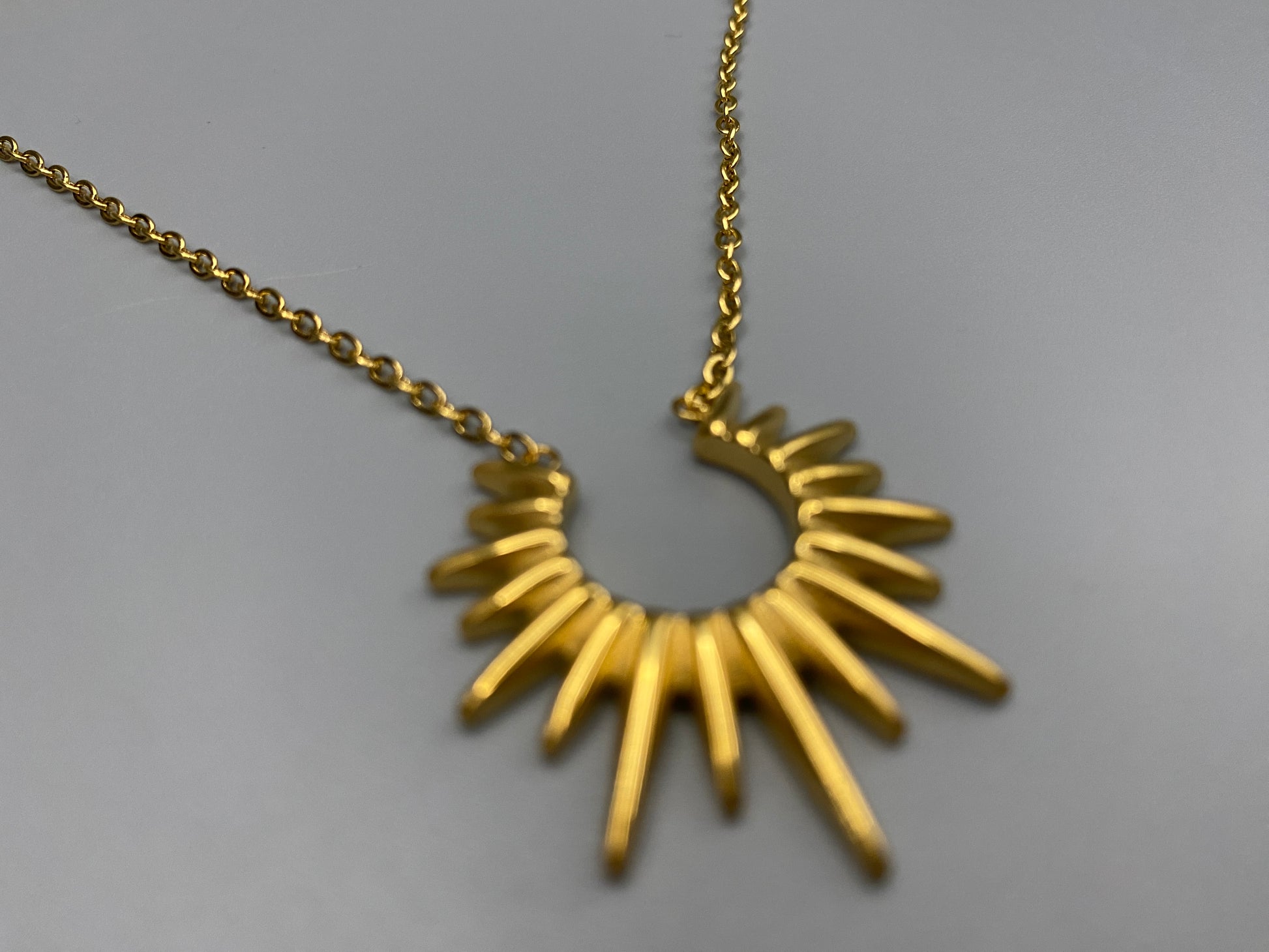 Sunburst Pendant Necklace Gold. Radiant and elegant. 18k gold plated pendant. Waterproof, non-tarnish, non-fade. Length: 45 cm + 5 cm extender. Stainless steel construction. Unique sunburst design.
