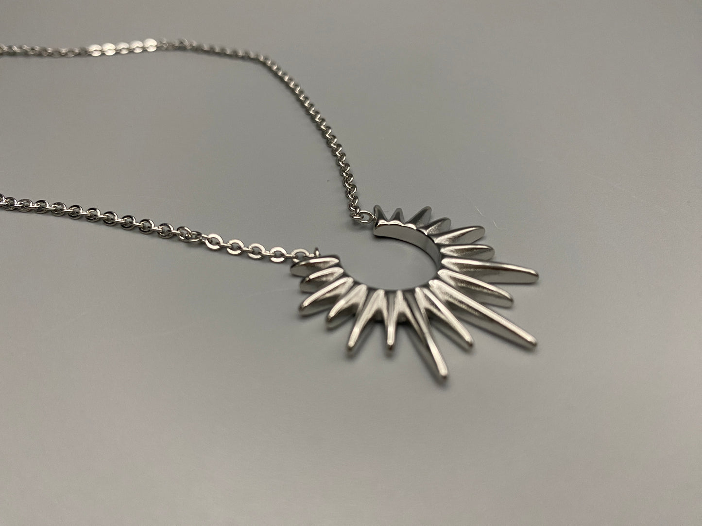 Sunburst Pendant Necklace Silver. Radiant and elegant. 18k gold plated pendant. Waterproof, non-tarnish, non-fade. Length: 45 cm + 5 cm extender. Stainless steel construction. Unique sunburst design.