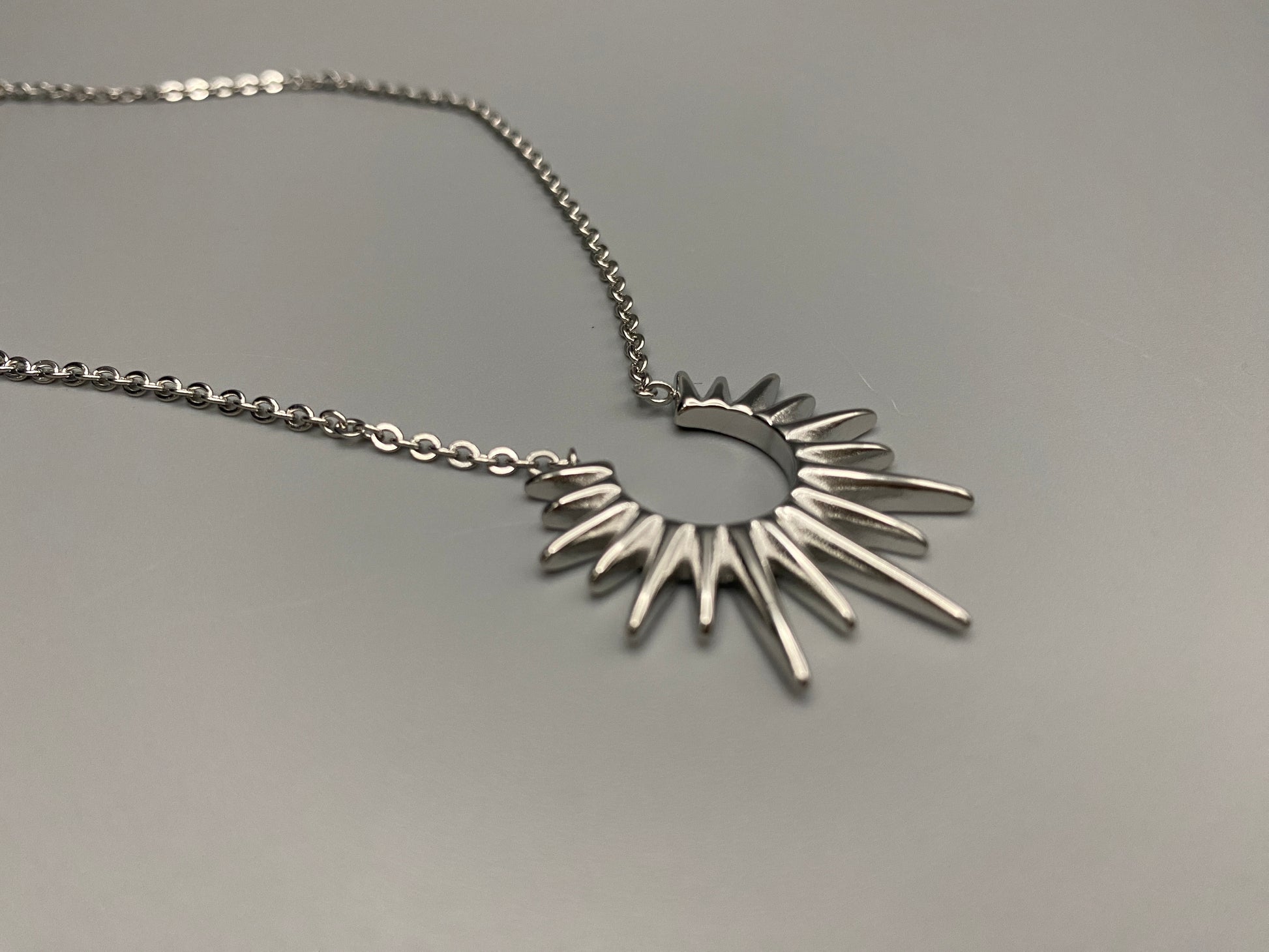 Sunburst Pendant Necklace Silver. Radiant and elegant. 18k gold plated pendant. Waterproof, non-tarnish, non-fade. Length: 45 cm + 5 cm extender. Stainless steel construction. Unique sunburst design.