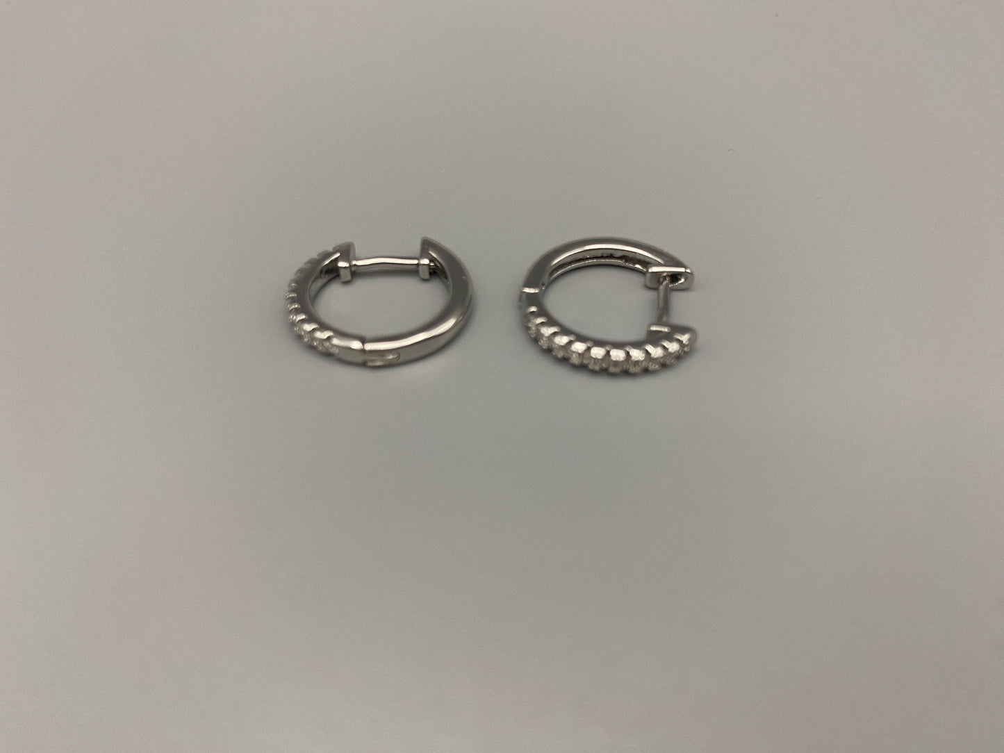 “Taga Elegant Hoop Earrings Silver: A perfect blend of sophistication and modern design, featuring silver plating for a luxurious finish, durable stainless steel construction, and sparkling zirconia gems. Stylish and contemporary, perfect for any occasion.”