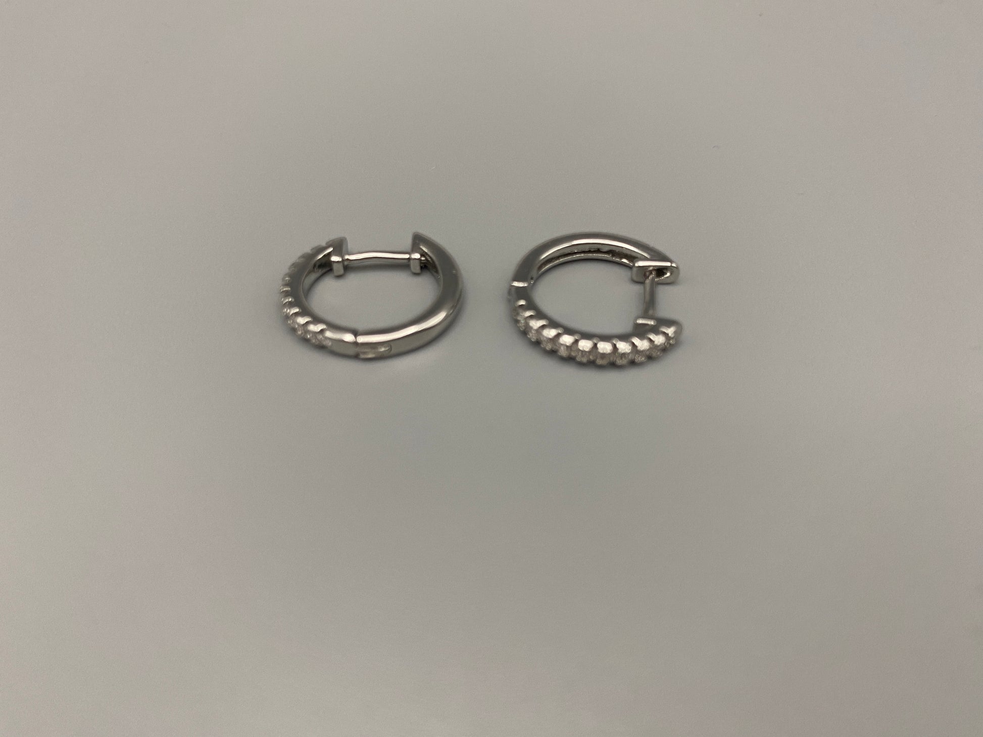 “Taga Elegant Hoop Earrings Silver: A perfect blend of sophistication and modern design, featuring silver plating for a luxurious finish, durable stainless steel construction, and sparkling zirconia gems. Stylish and contemporary, perfect for any occasion.”
