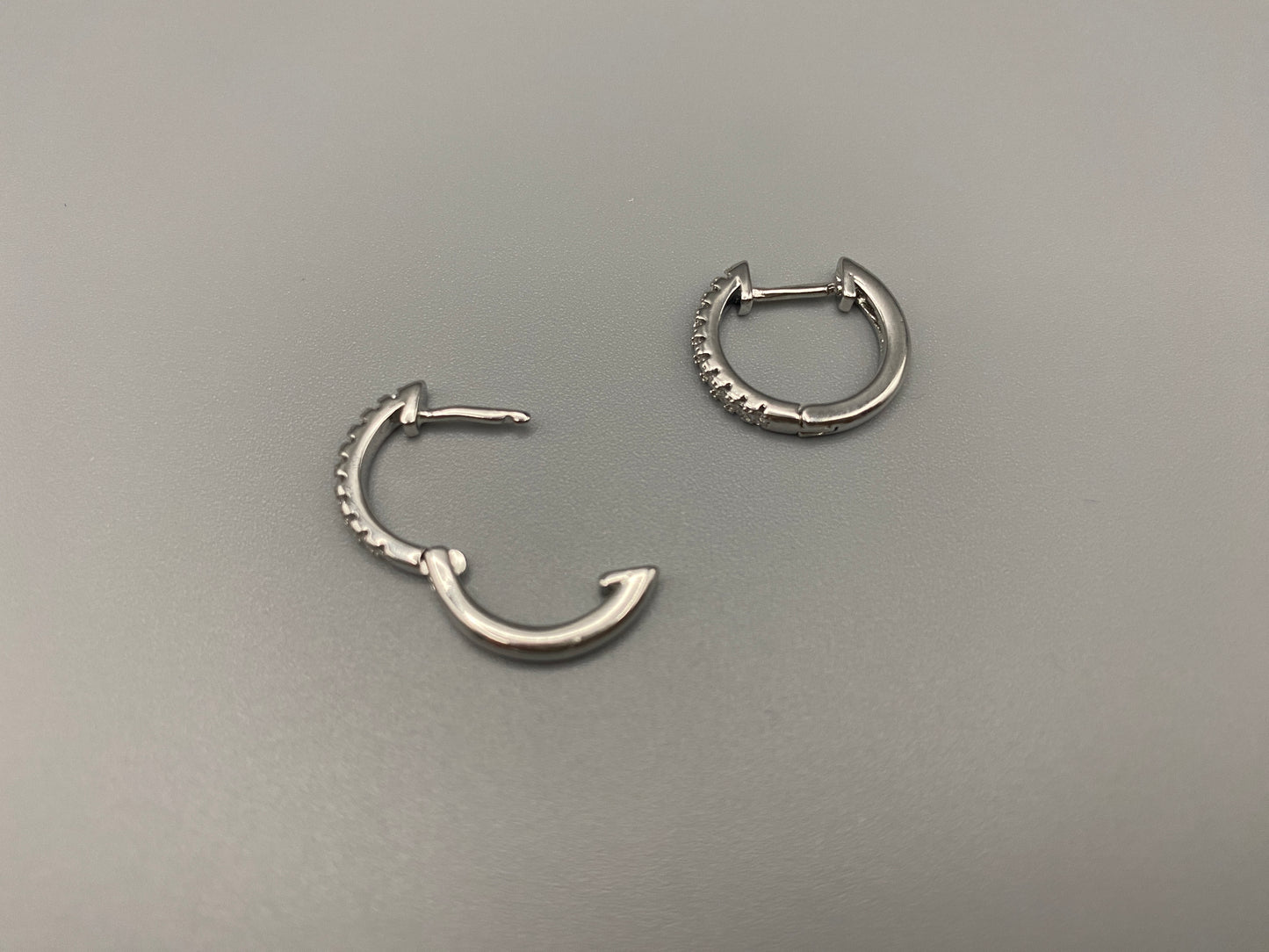“Taga Elegant Hoop Earrings Silver: A perfect blend of sophistication and modern design, featuring silver plating for a luxurious finish, durable stainless steel construction, and sparkling zirconia gems. Stylish and contemporary, perfect for any occasion.”