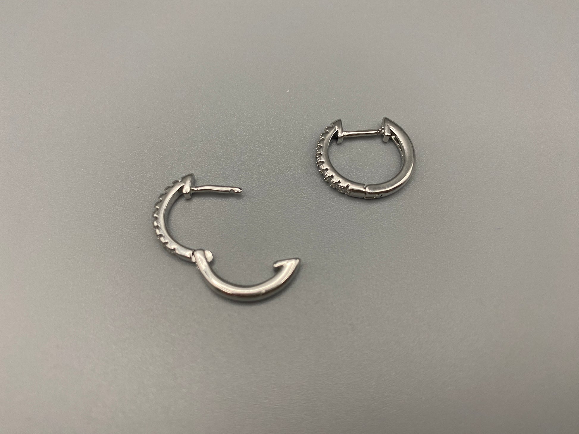 “Taga Elegant Hoop Earrings Silver: A perfect blend of sophistication and modern design, featuring silver plating for a luxurious finish, durable stainless steel construction, and sparkling zirconia gems. Stylish and contemporary, perfect for any occasion.”
