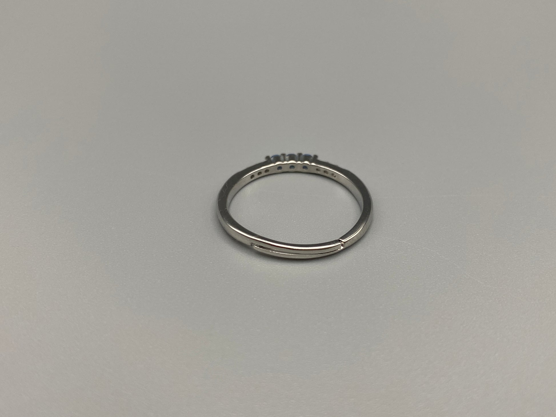 Tanvi Blue Ring: This stunning piece features alternating brilliant blue and clear cubic zirconia stones, set in a sleek silver-plated band. The adjustable fit ensures comfort for any finger size. The ring is non-tarnish and waterproof, maintaining its shine over time. Perfect for everyday wear, the Tanvi ring is your go-to accessory for timeless beauty.