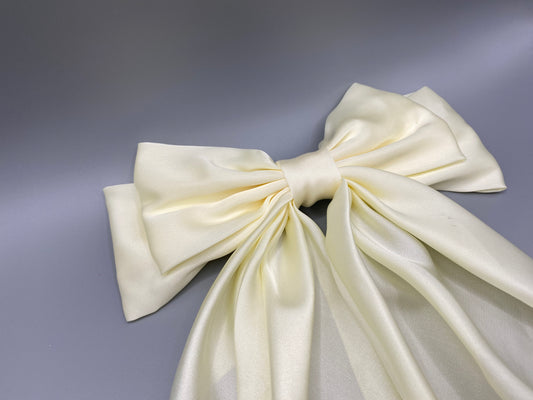 “The Amy Oversized Hair Bow in Cream, crafted from high-quality satin with an oversized bowknot design. Features a minimalist spring clamp for a secure fit. Perfect for stylish updos, daily wear, and special occasions.”