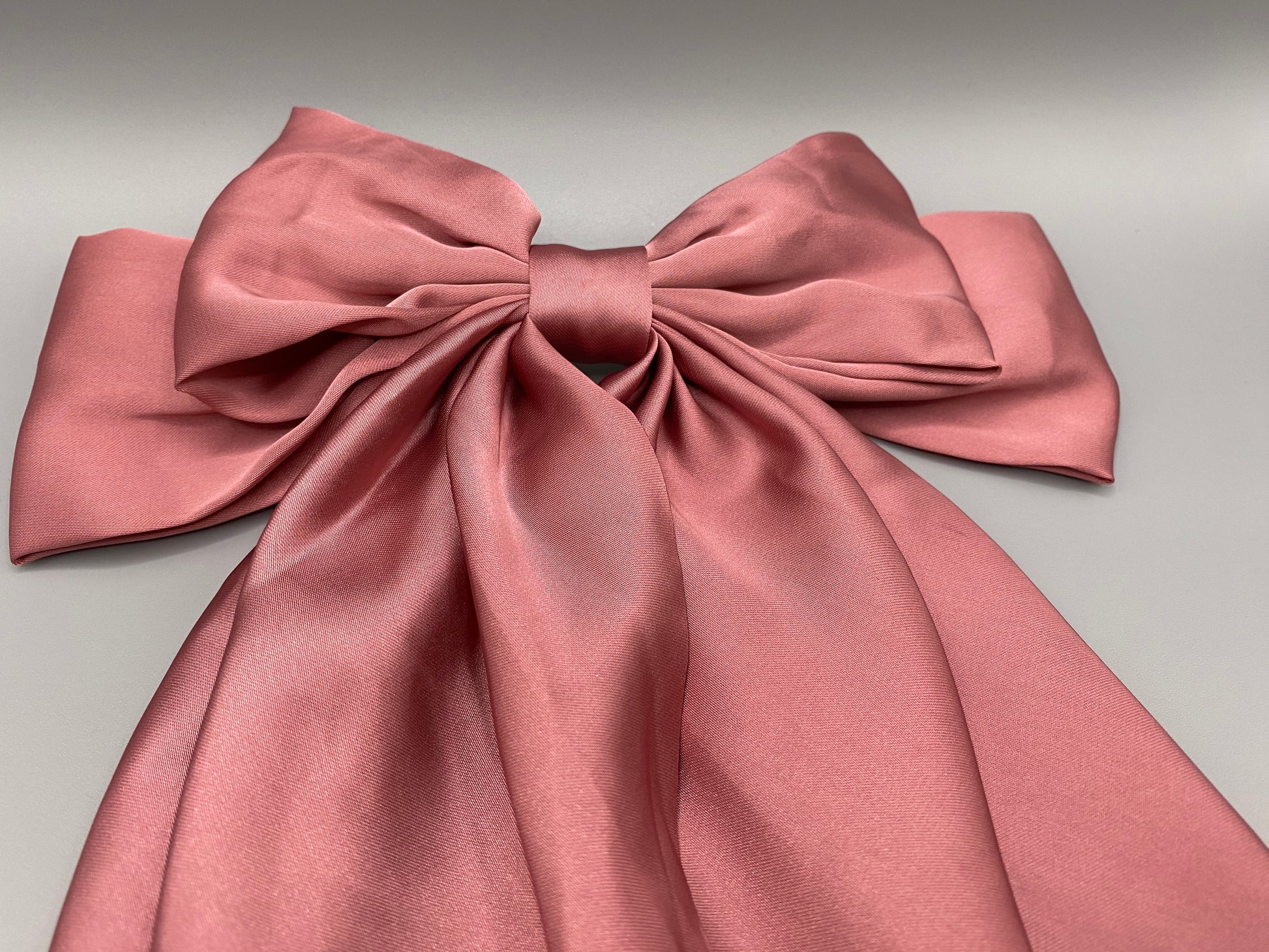 “The Amy Oversized Hair Bow in Pink, crafted from high-quality satin with an oversized bowknot design. Features a minimalist spring clamp for a secure fit. Perfect for stylish updos, daily wear, and special occasions.”