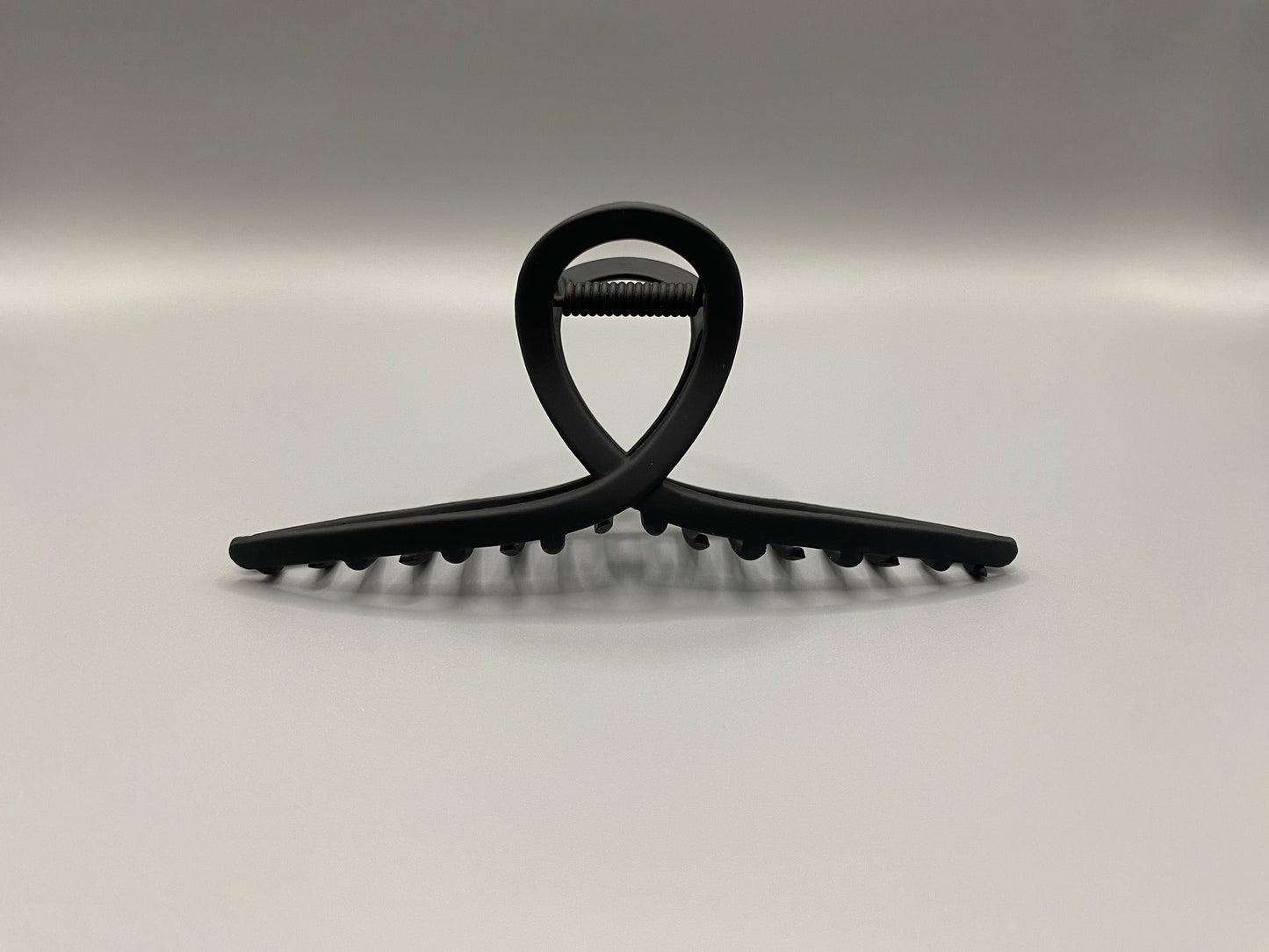 The Bethany Claw Grip Clip in Black, crafted from high-quality metal with a matte black finish. Measures 11 cm, designed for a secure hold and suitable for various hair types and styles. Durable and stylish, perfect for any outfit.”