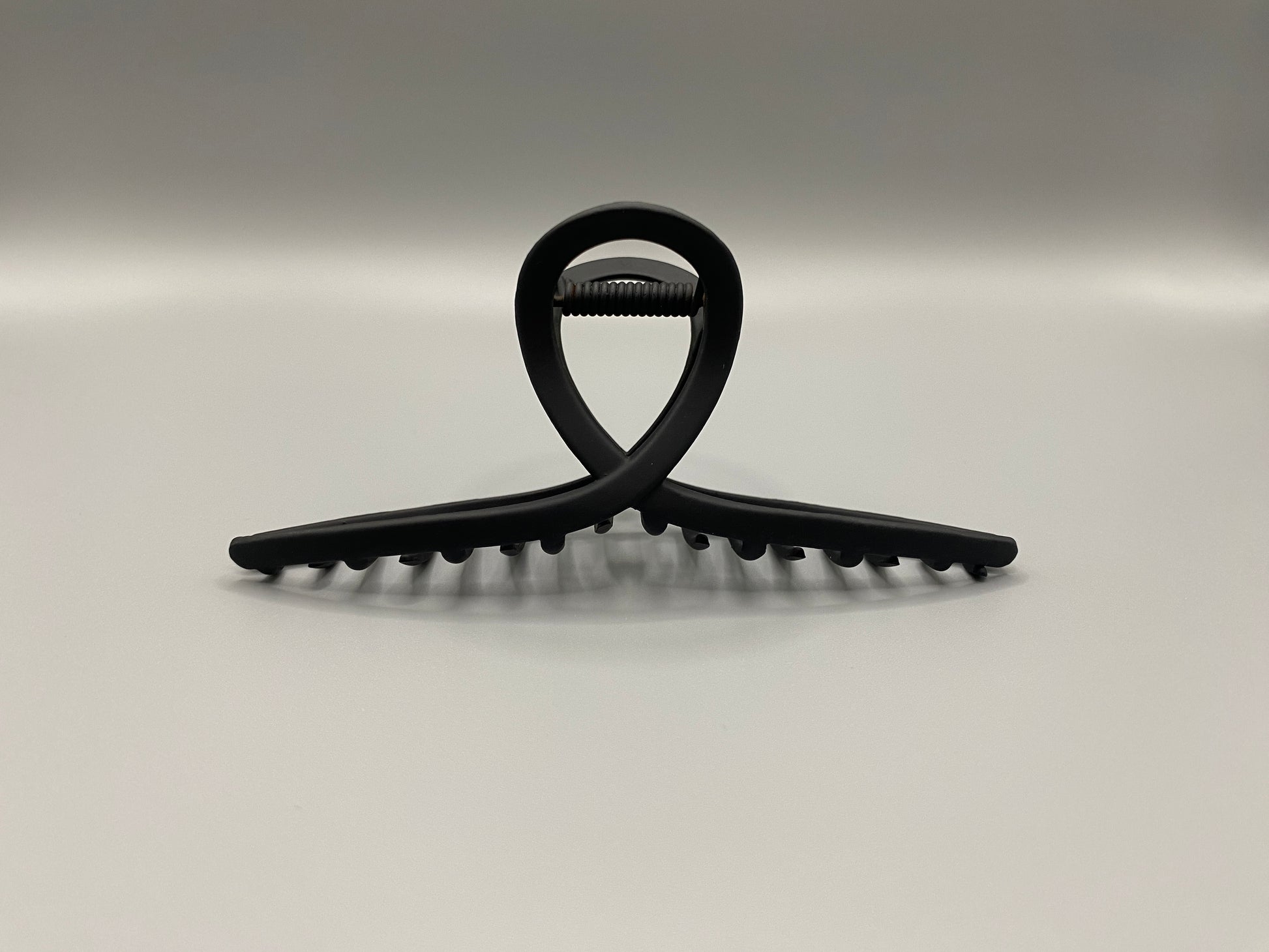 The Bethany Claw Grip Clip in Black, crafted from high-quality metal with a matte black finish. Measures 11 cm, designed for a secure hold and suitable for various hair types and styles. Durable and stylish, perfect for any outfit.”