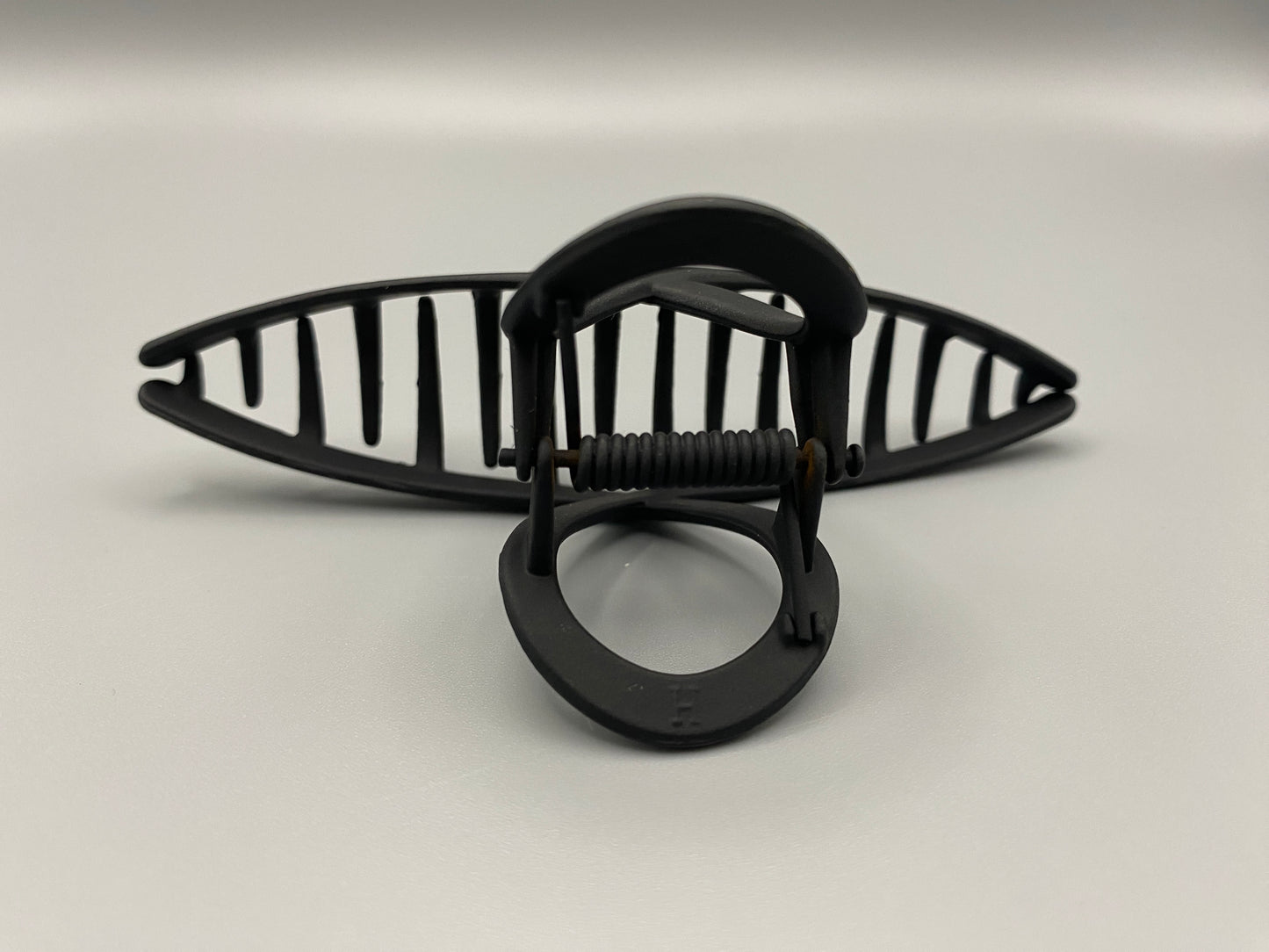 The Bethany Claw Grip Clip in Black, crafted from high-quality metal with a matte black finish. Measures 11 cm, designed for a secure hold and suitable for various hair types and styles. Durable and stylish, perfect for any outfit.”