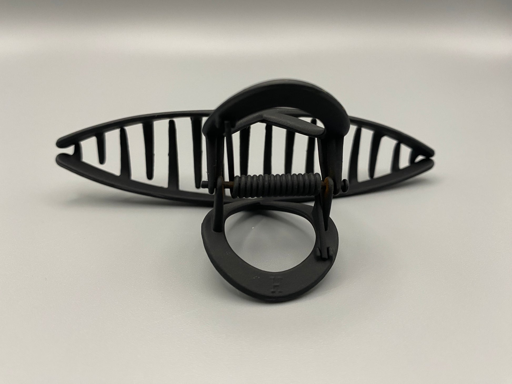 The Bethany Claw Grip Clip in Black, crafted from high-quality metal with a matte black finish. Measures 11 cm, designed for a secure hold and suitable for various hair types and styles. Durable and stylish, perfect for any outfit.”