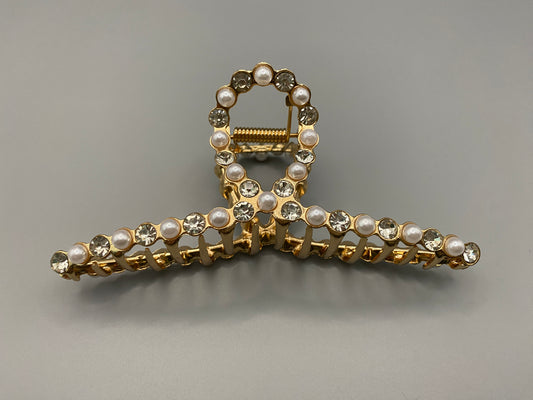 “The Luxe Claw Clip Pearl and Gem Inlay in Gold, crafted from high-quality, durable metal. Measures 11 cm, featuring a luxurious gold finish with beautiful pearl and gem accents. Perfect for securing various hair types and styles, suitable for both everyday wear and special occasions.”