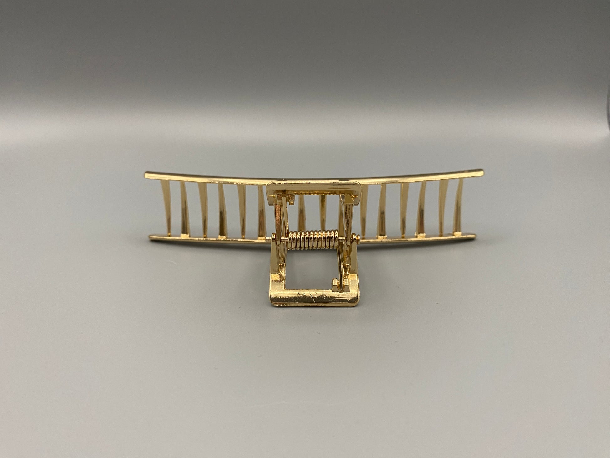 “The Luxe Claw Clip Metal Bow in Gold, crafted from high-quality, durable metal. Measures 11 cm, featuring a luxurious gold finish and unique link design. Perfect for securing various hair types and styles, suitable for both everyday wear and special occasions.”