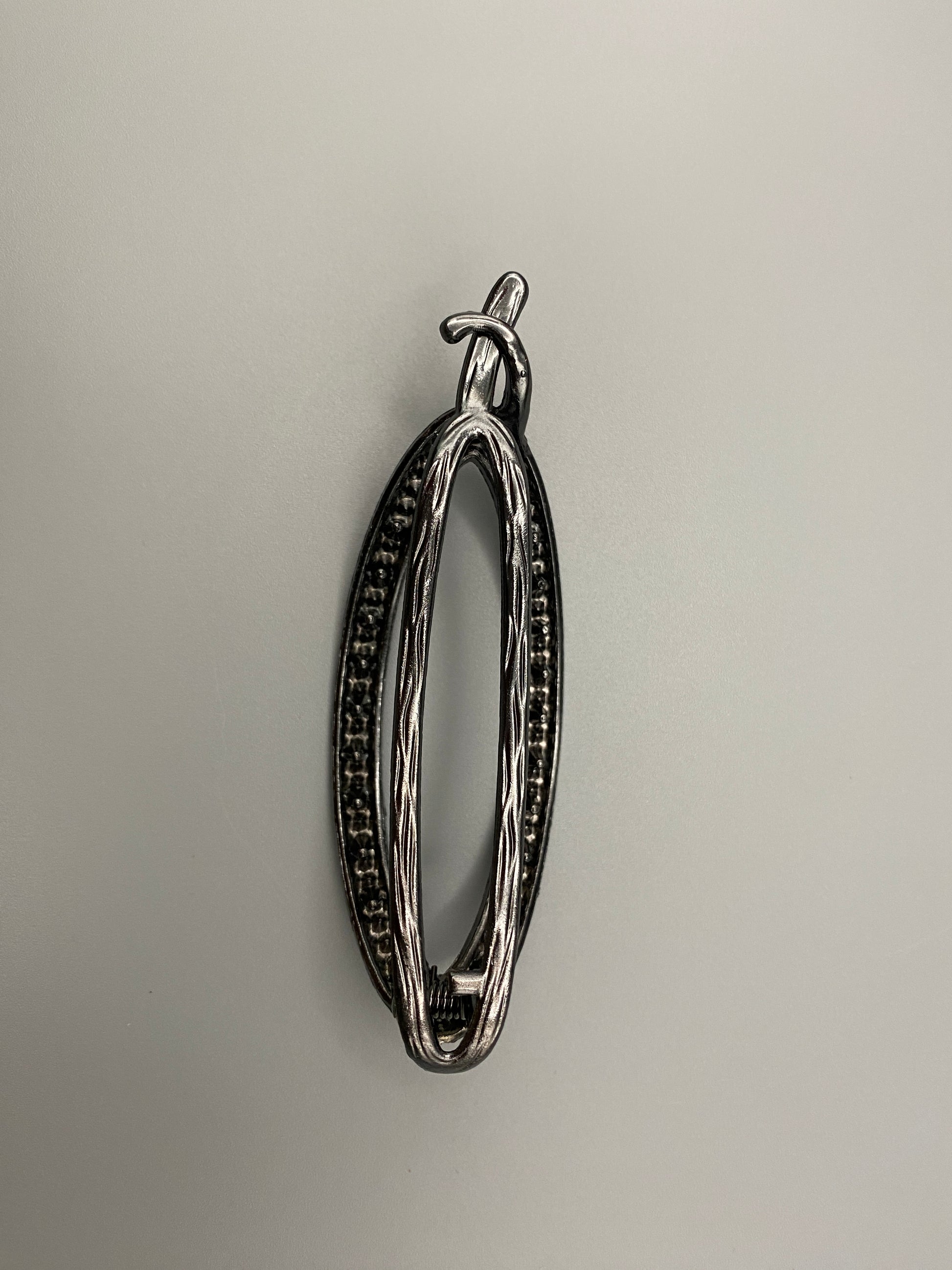 “The Missy Hair Clip, crafted from high-quality metal with sparkling zircon inlaid stones. Features a delicate curved design, measures 9 cm in length, and is perfect for securing various hair types and styl
