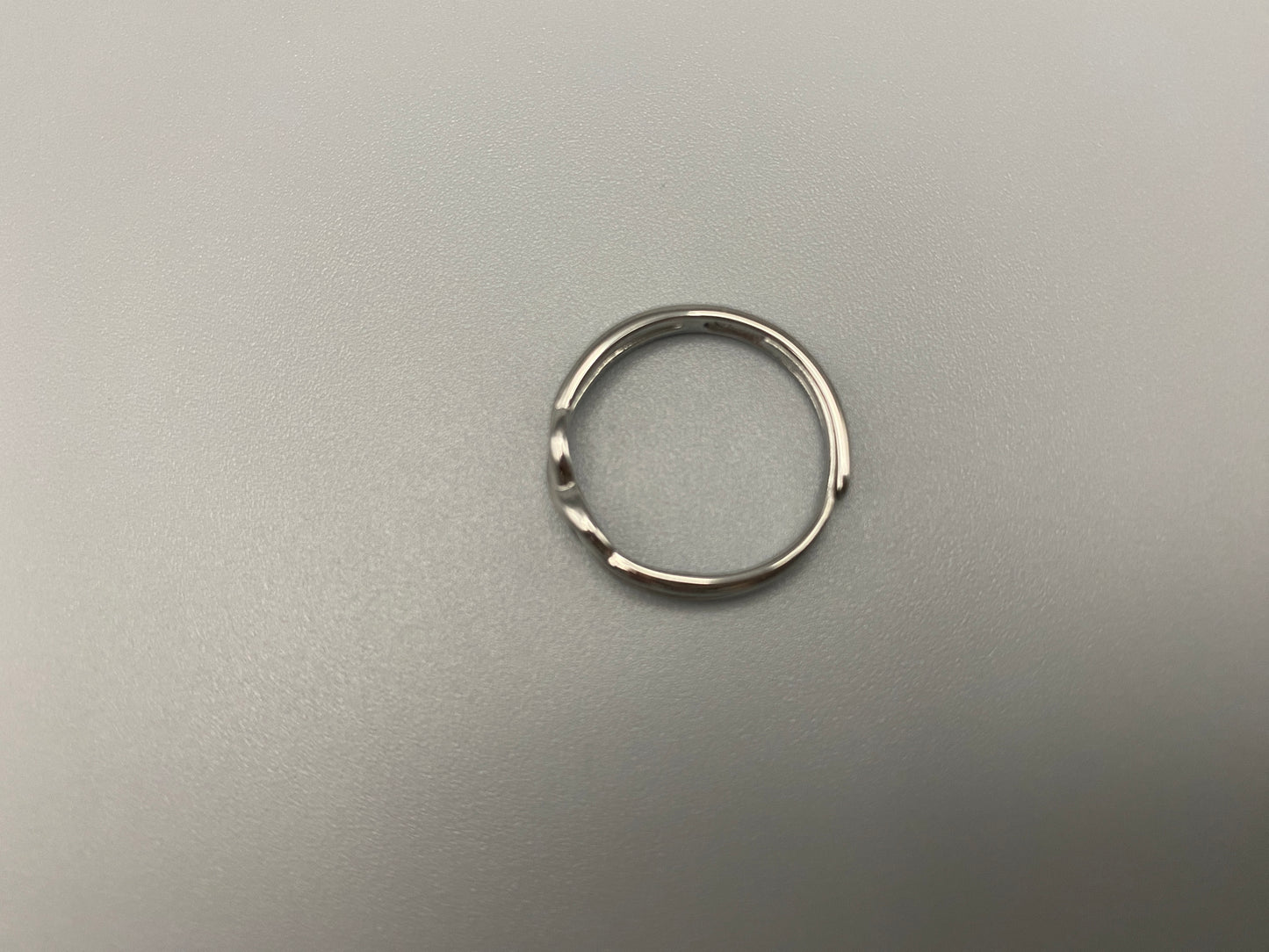 Tiana Silver Ring: Crafted from high-quality 316L stainless steel, this ring features a sleek, intertwined design that exudes sophistication. The adjustable, free-size band ensures a comfortable fit for any finger. Perfect for adding a trendy touch to any outfit.