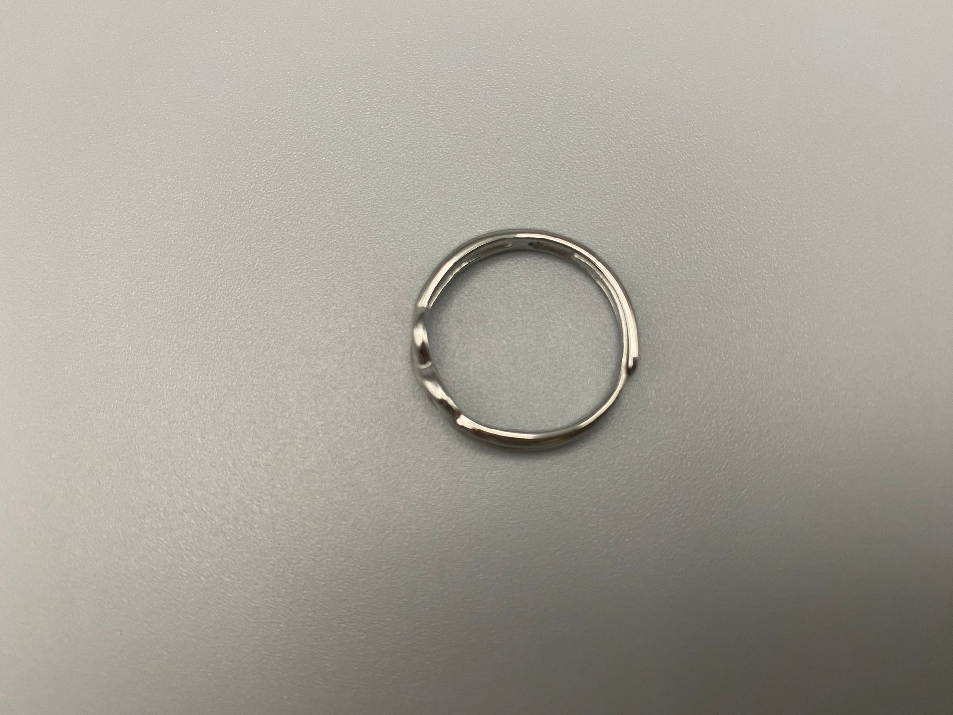 Tiana Silver Ring: Crafted from high-quality 316L stainless steel, this ring features a sleek, intertwined design that exudes sophistication. The adjustable, free-size band ensures a comfortable fit for any finger. Perfect for adding a trendy touch to any outfit.