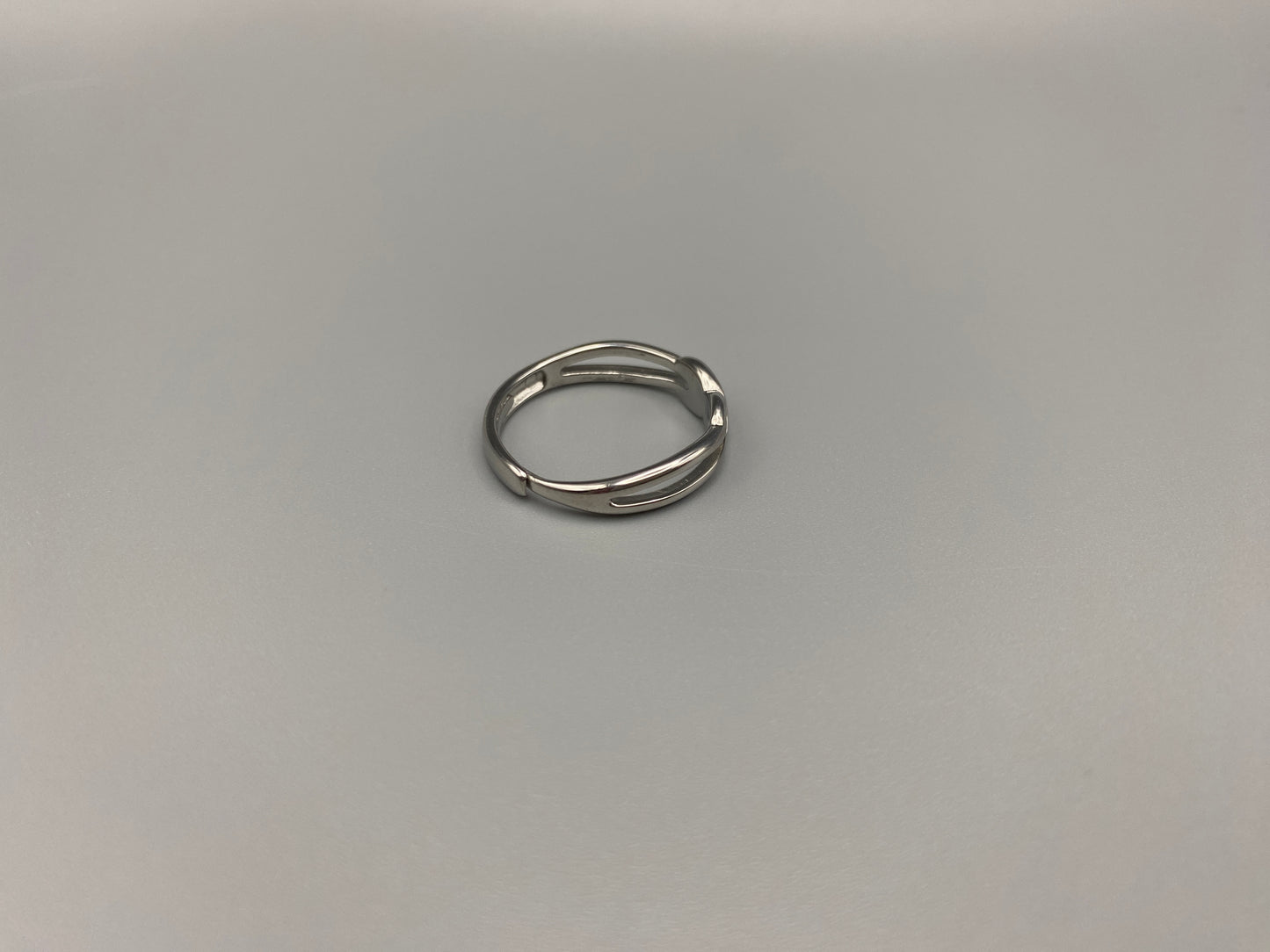Tiana Silver Ring: Crafted from high-quality 316L stainless steel, this ring features a sleek, intertwined design that exudes sophistication. The adjustable, free-size band ensures a comfortable fit for any finger. Perfect for adding a trendy touch to any outfit.