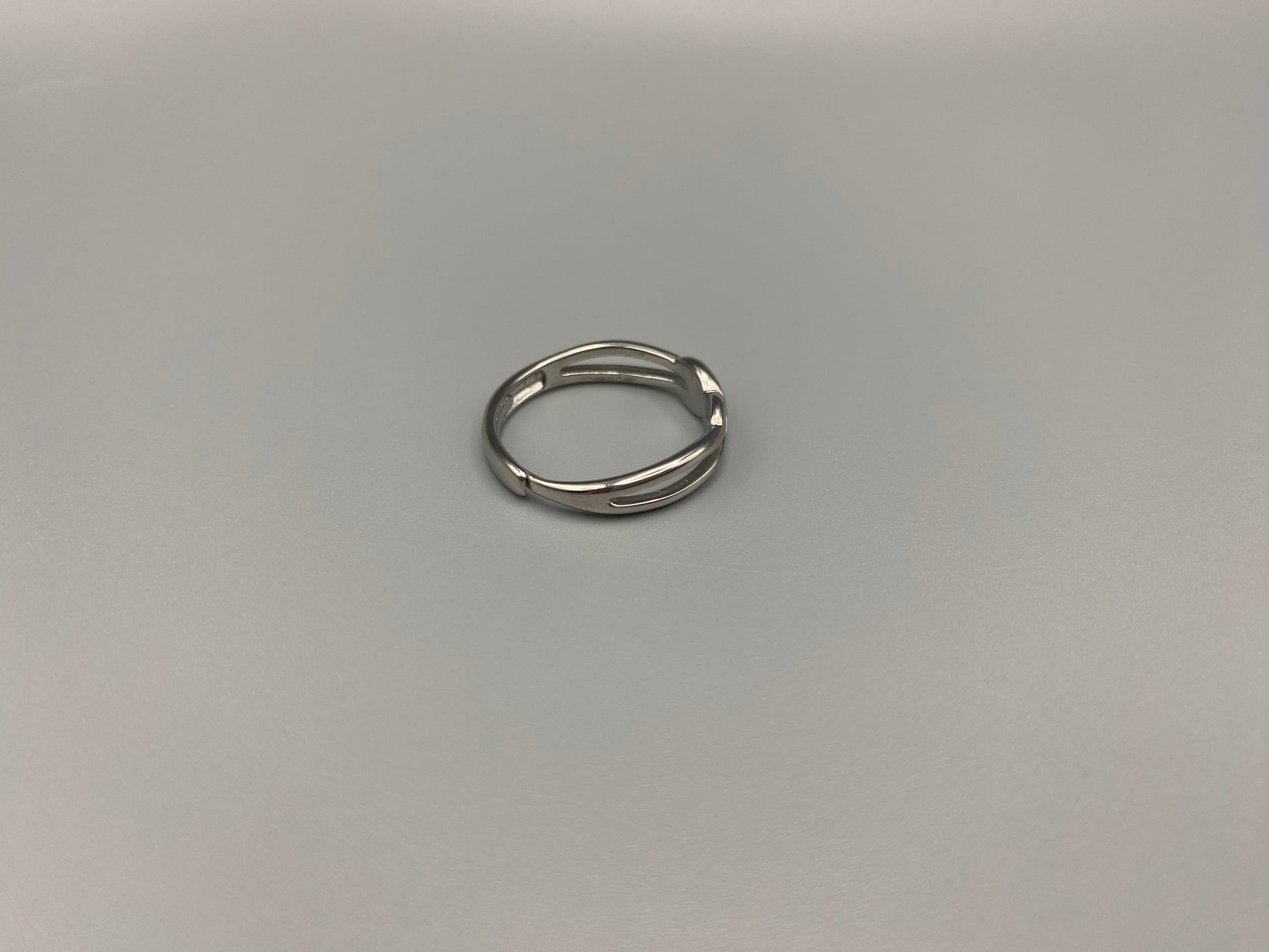 Tiana Silver Ring: Crafted from high-quality 316L stainless steel, this ring features a sleek, intertwined design that exudes sophistication. The adjustable, free-size band ensures a comfortable fit for any finger. Perfect for adding a trendy touch to any outfit.