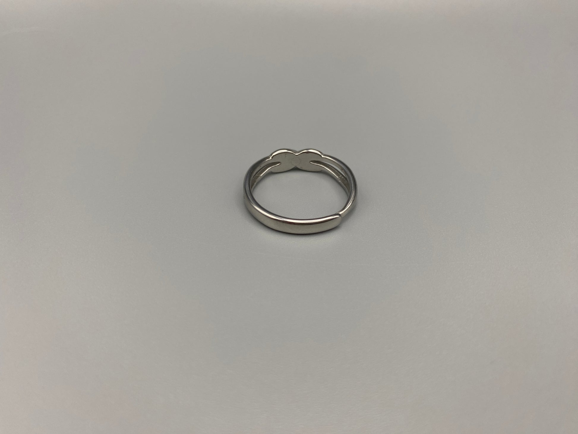 Tiana Silver Ring: Crafted from high-quality 316L stainless steel, this ring features a sleek, intertwined design that exudes sophistication. The adjustable, free-size band ensures a comfortable fit for any finger. Perfect for adding a trendy touch to any outfit.