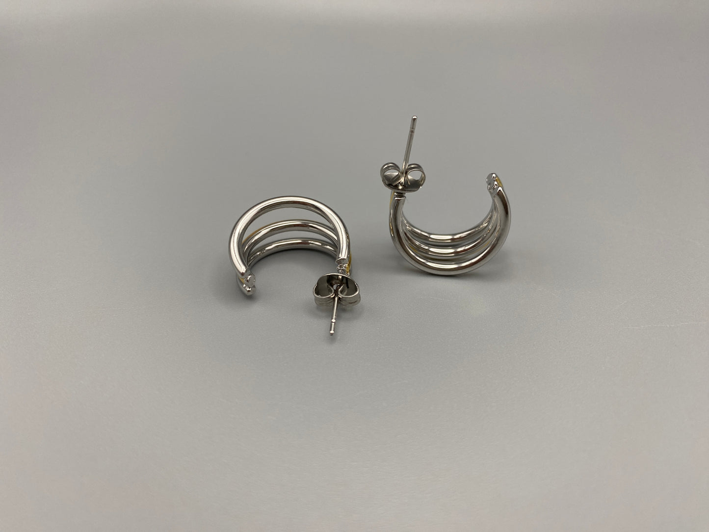 “Trinity 3 Band C Shaped Earrings Gold and Silver: A perfect blend of elegance and modern design, featuring sleek gold and silver bands, a luxurious gold-plated band, and durable stainless steel construction. Unique three-band C shape, ideal for any occasion.”