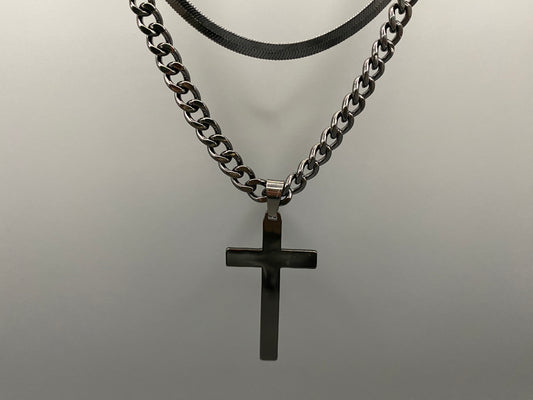 “Men’s Twin Chain Cross Necklace: A stylish black stainless steel necklace featuring a twin chain design with a plated cross pendant. Perfect for teens and adults, this fine jewelry piece is unisex and measures 45 cm with a 5 cm extender.”