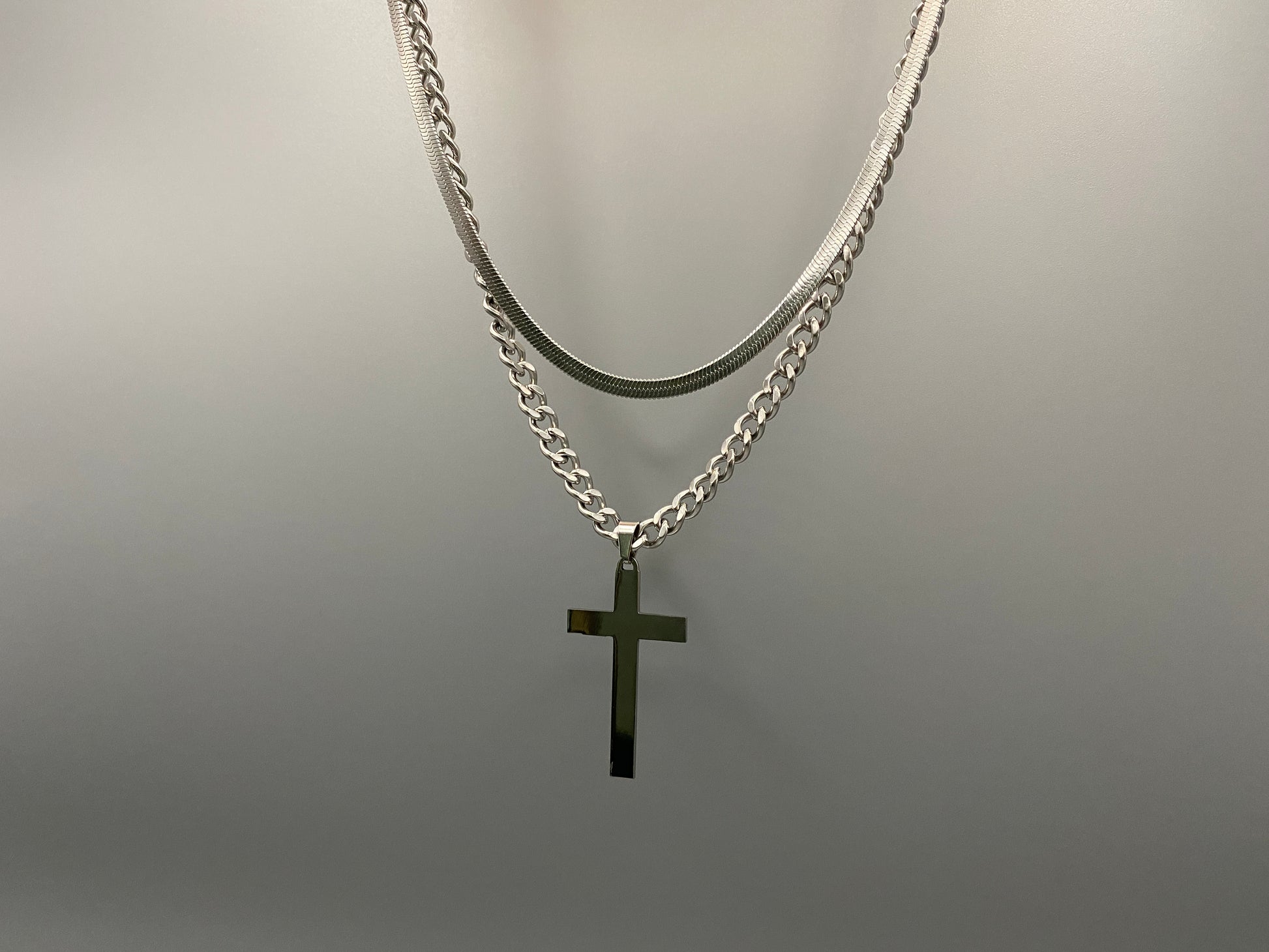 This elegant twin chain cross necklace features a striking black cross pendant, perfect for adding a touch of sophistication to any outfit. The necklace combines a thicker rope chain with a thinner snake chain, offering a unique and stylish look. Crafted from high-quality stainless steel, this piece is designed to last and maintain its shine.&nbsp;

Key Attributes:

Jewelry Main Material:&nbsp;Stainless steel
Shape/Pattern:&nbsp;Cross
Chain Length:&nbsp;Cross chain 25cm, Snake chain length 45 cm + 5 cm exte