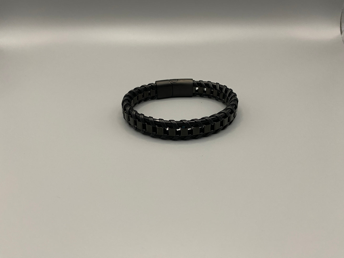 “Urban Edge Wrist Wear Men’s Bracelet in black, crafted from premium stainless steel with a casual and sporty design. Measures 19 cm in length, available in Black Zinc Plated, 18K Gold Plated, and Silver Plated finishes. Features inlay technology for added detail and craftsmanship.”