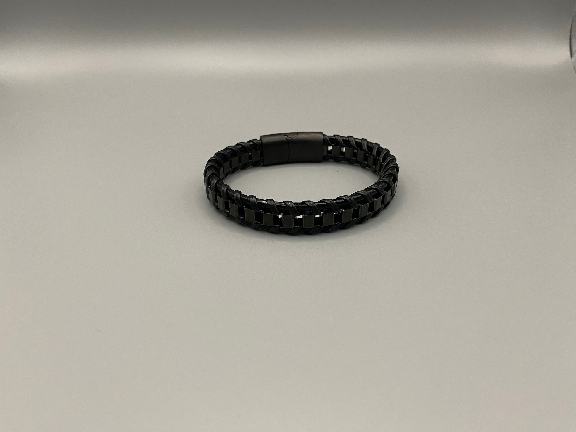 “Urban Edge Wrist Wear Men’s Bracelet in black, crafted from premium stainless steel with a casual and sporty design. Measures 19 cm in length, available in Black Zinc Plated, 18K Gold Plated, and Silver Plated finishes. Features inlay technology for added detail and craftsmanship.”