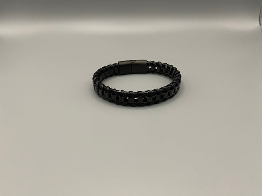 “Urban Edge Wrist Wear Men’s Bracelet in black, crafted from premium stainless steel with a casual and sporty design. Measures 19 cm in length, available in Black Zinc Plated, 18K Gold Plated, and Silver Plated finishes. Features inlay technology for added detail and craftsmanship.”