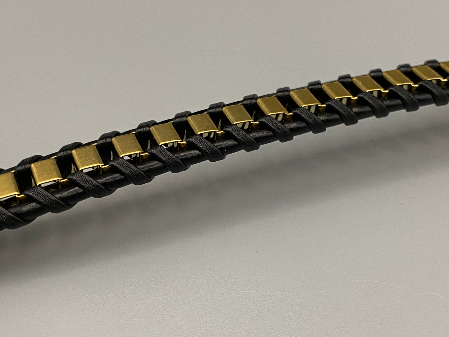 “Urban Edge Wrist Wear Men’s Bracelet in black, crafted from premium stainless steel with a casual and sporty design. Measures 19 cm in length, available in Black Zinc Plated, 18K Gold Plated, and Silver Plated finishes. Features inlay technology for added detail and craftsmanship.”
