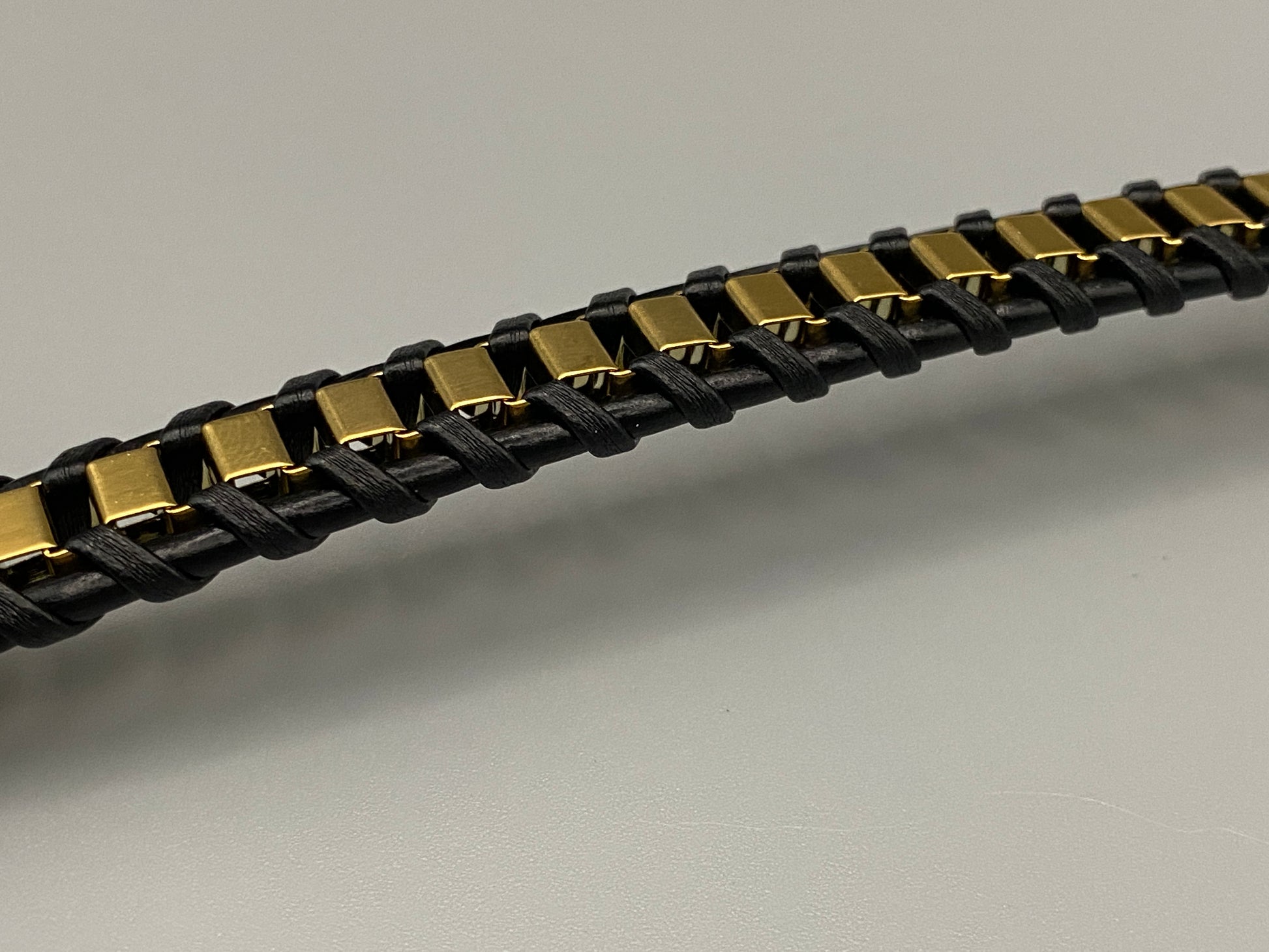 “Urban Edge Wrist Wear Men’s Bracelet in black, crafted from premium stainless steel with a casual and sporty design. Measures 19 cm in length, available in Black Zinc Plated, 18K Gold Plated, and Silver Plated finishes. Features inlay technology for added detail and craftsmanship.”