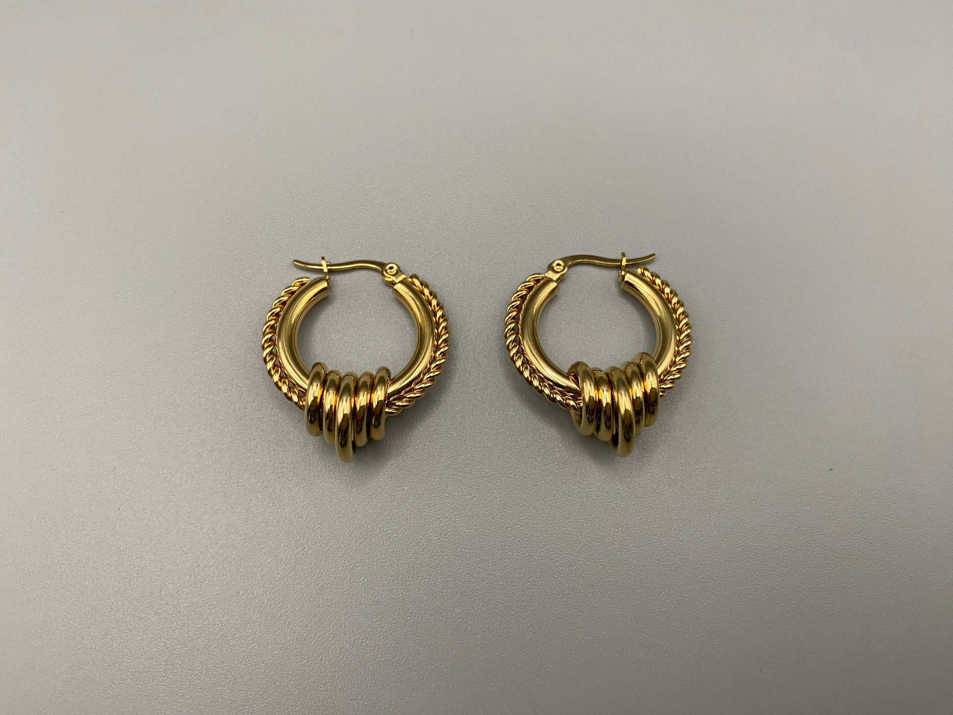 “Vespera Gold Earrings: A perfect blend of elegance and modernity, crafted from hypoallergenic 316L stainless steel and plated with luxurious 18K gold. Durable and high-quality, ideal for sensitive ears and long-lasting shine.”